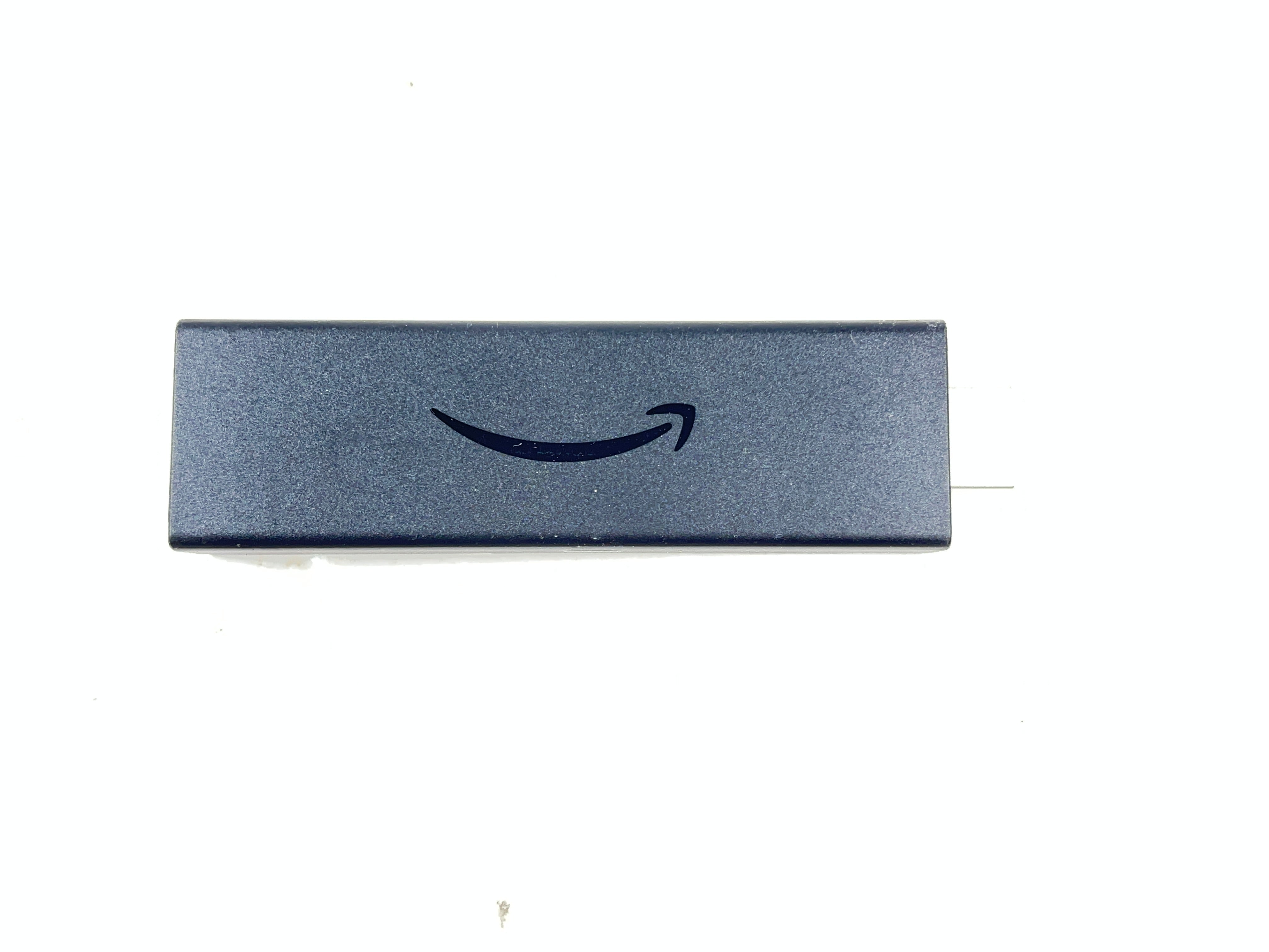 Dark blue Amazon Fire TV Stick with HDMI plug and Amazon smile logo shown from multiple angles