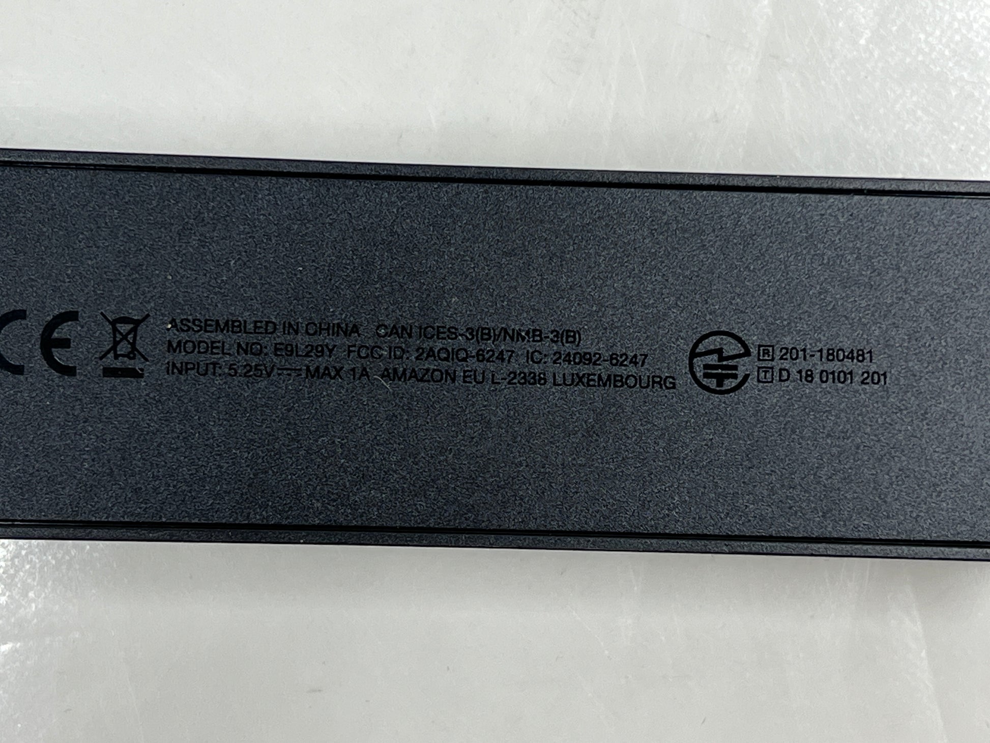 Dark blue Amazon Fire TV Stick with HDMI plug and Amazon smile logo shown from multiple angles