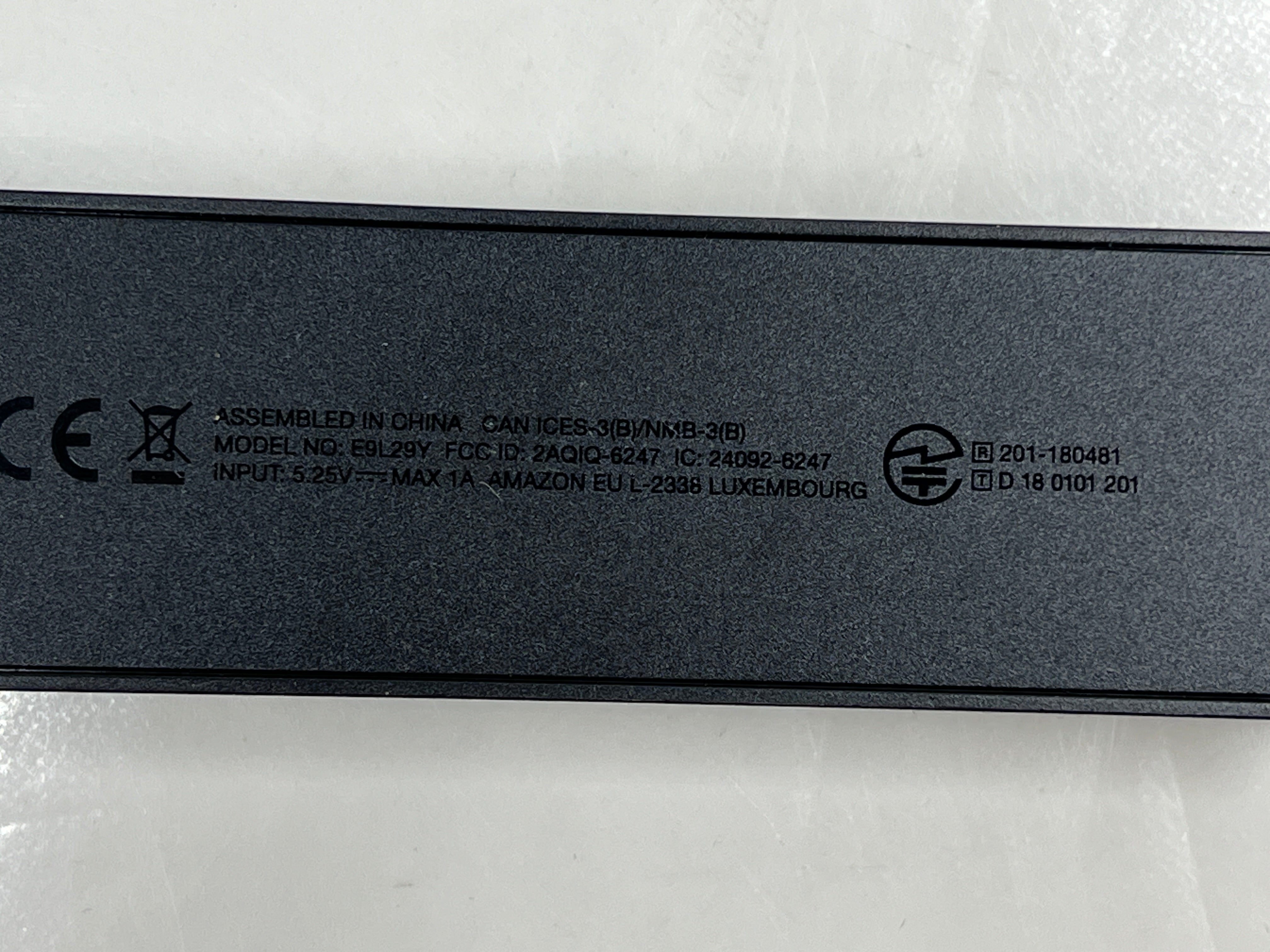 Dark blue Amazon Fire TV Stick with HDMI plug and Amazon smile logo shown from multiple angles