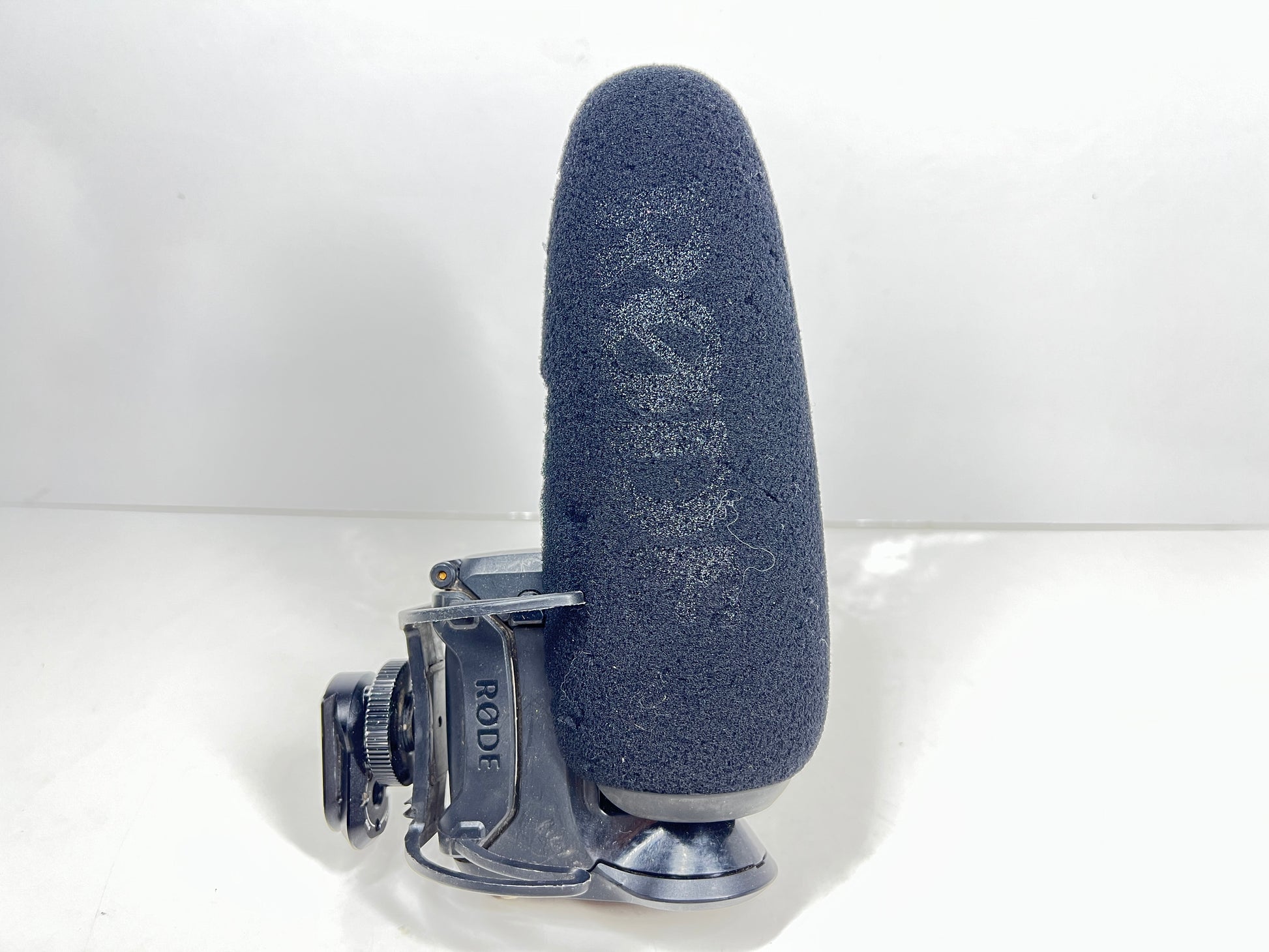 Used Rode VideoMic Pro shotgun microphone with damaged foam windscreen and visible onboard audio controls.