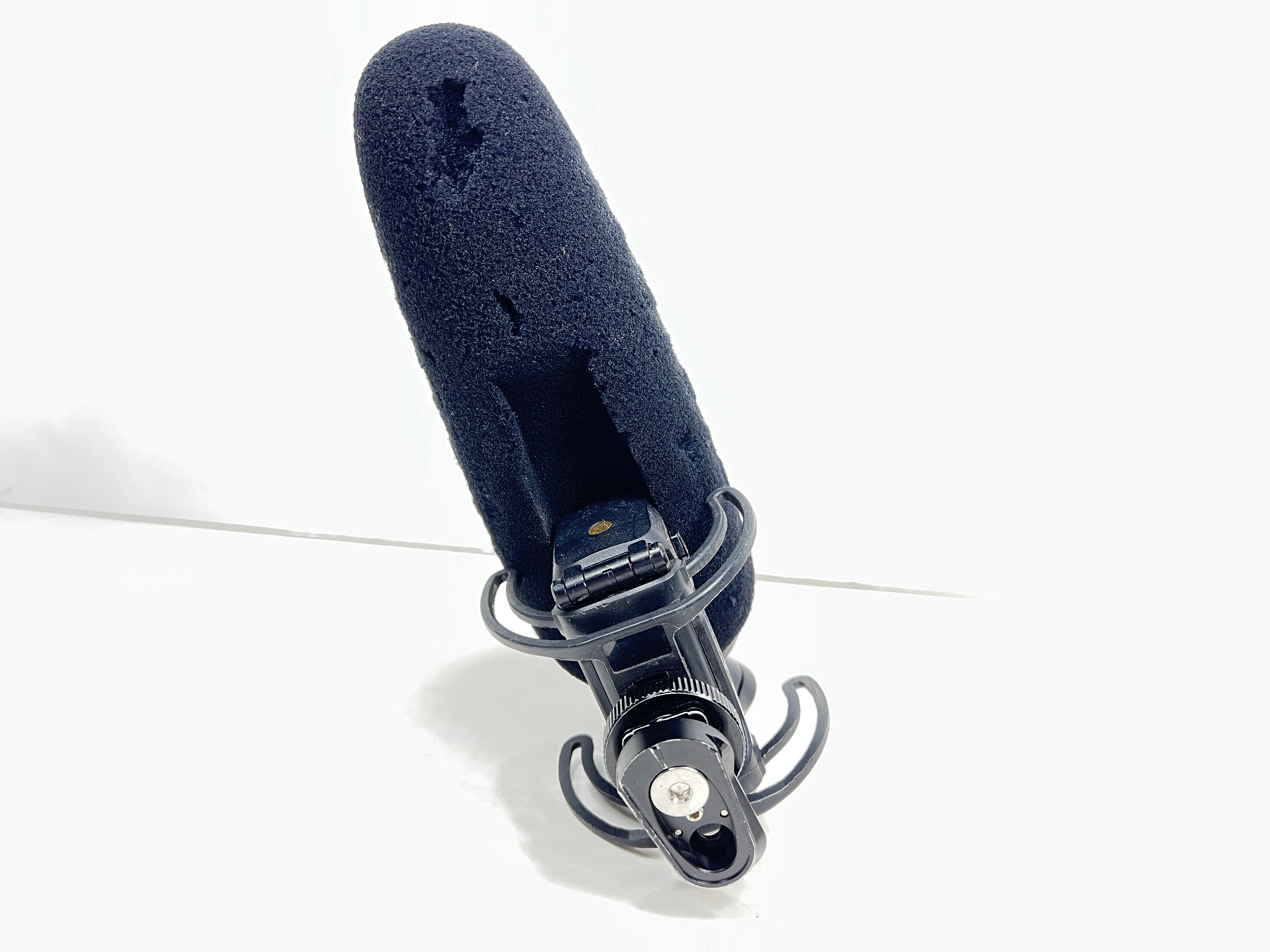 Used Rode VideoMic Pro shotgun microphone with damaged foam windscreen and visible onboard audio controls.
