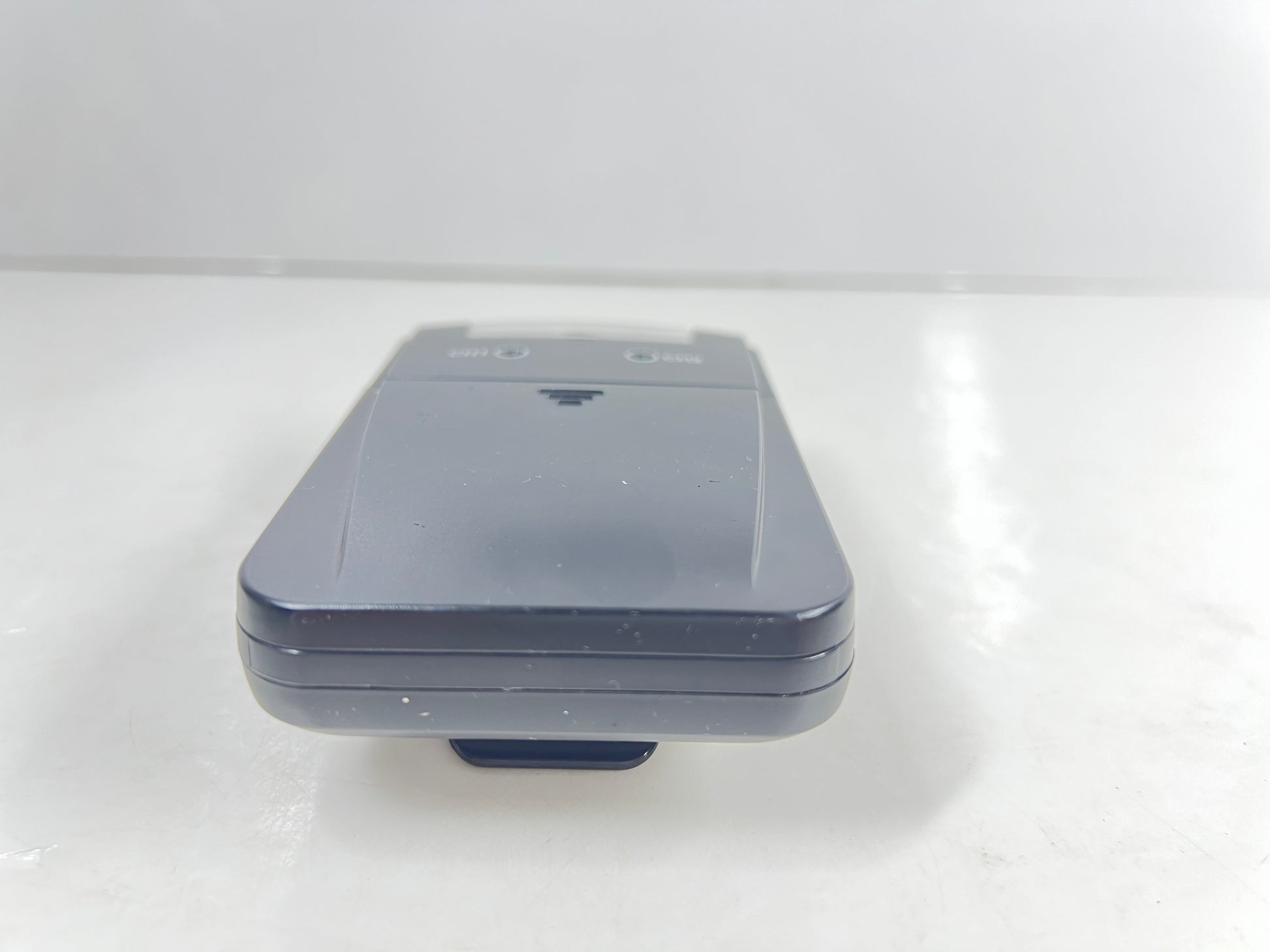 Close-up of black AMG Medical dual-channel TENS unit with belt clip and CH1/CH2 dials
