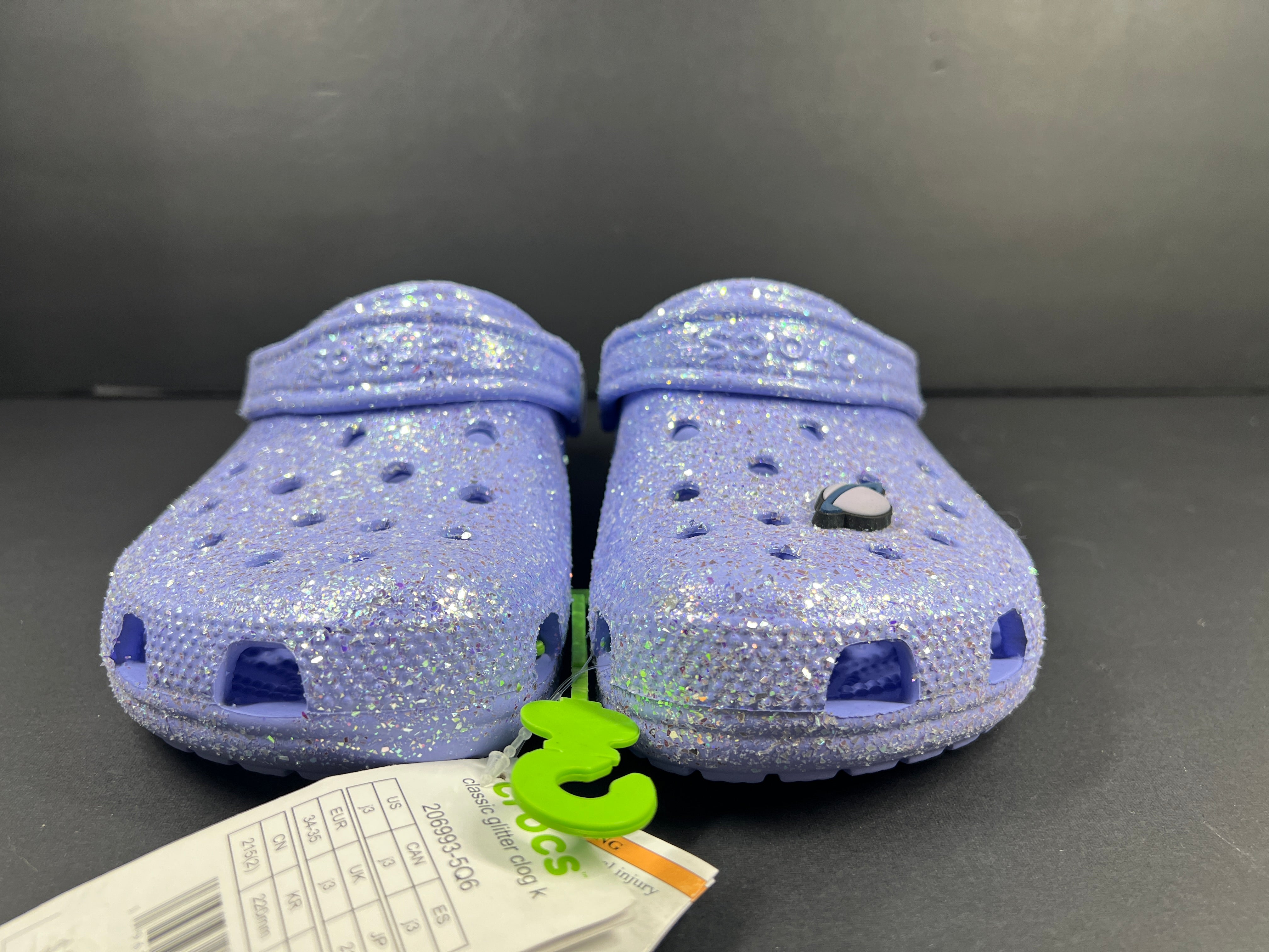 A pair of purple Crocs Classic Glitter Clogs