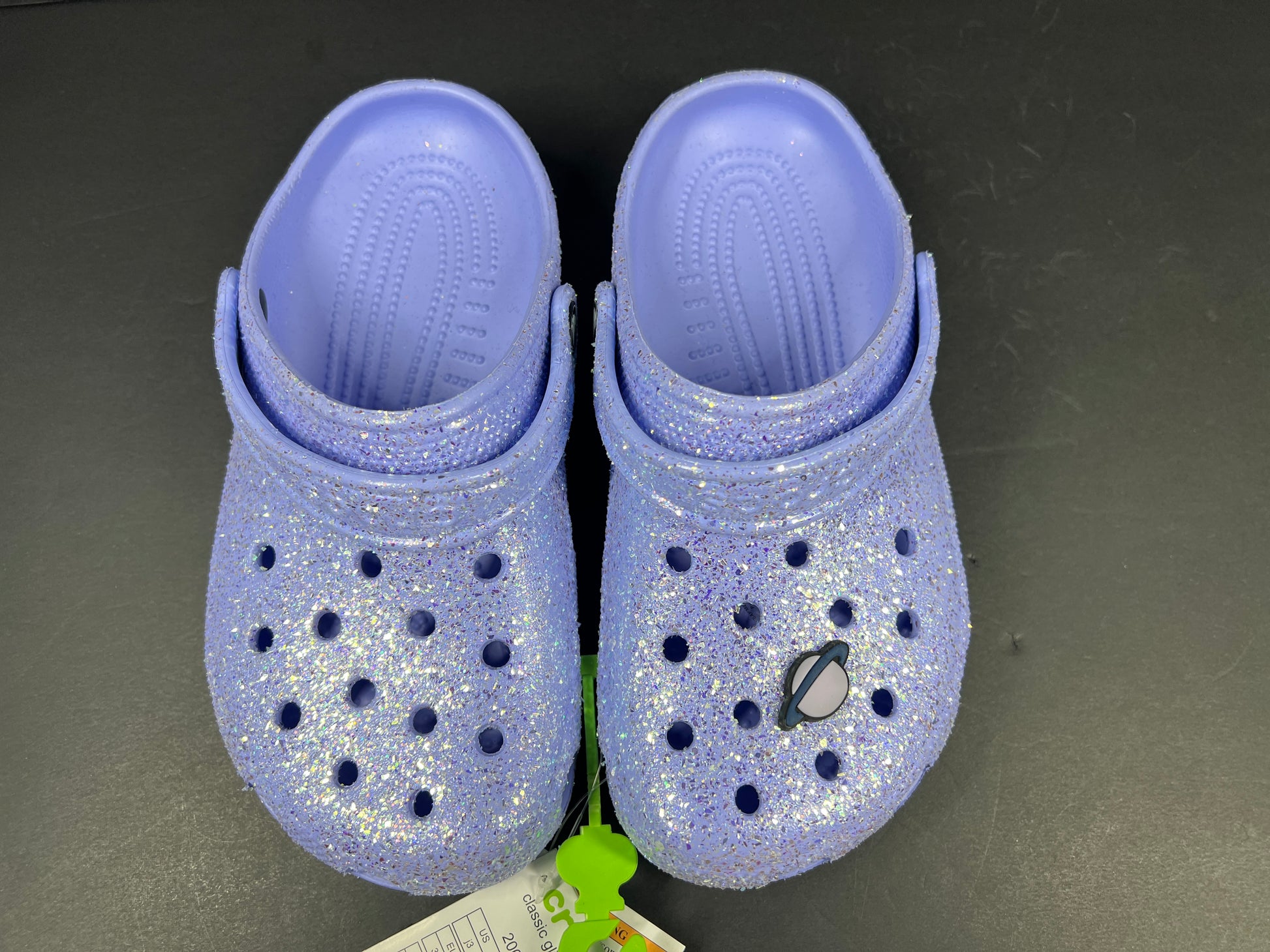 A pair of purple Crocs Classic Glitter Clogs
