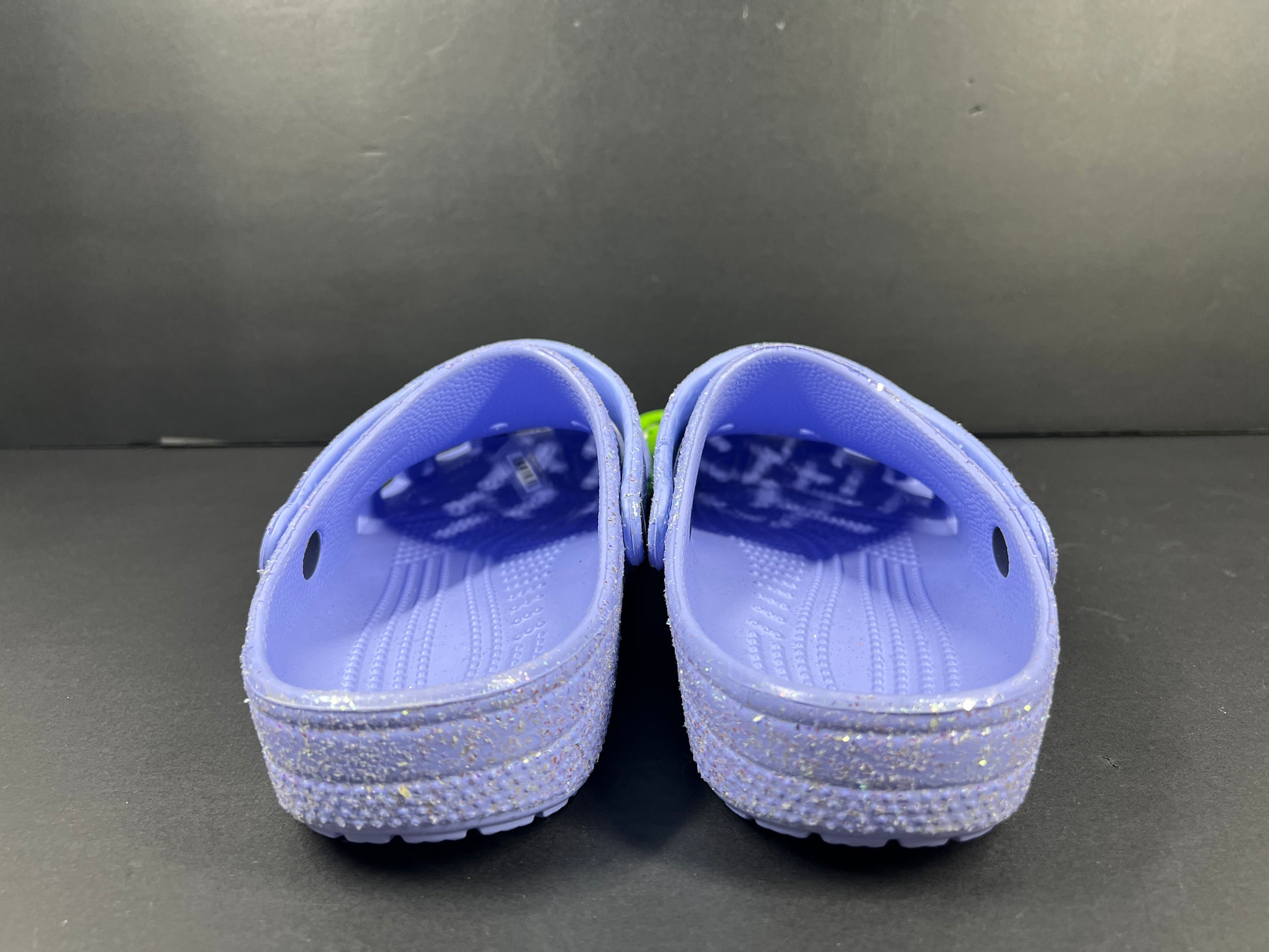 A pair of purple Crocs Classic Glitter Clogs
