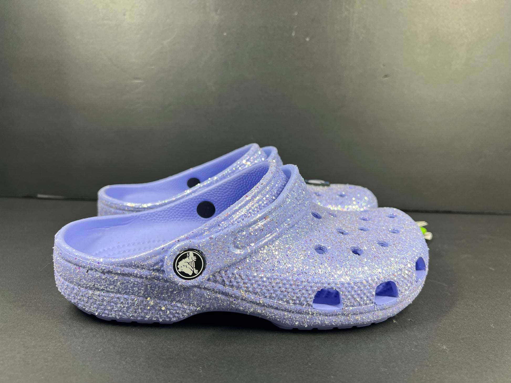 A pair of purple Crocs Classic Glitter Clogs
