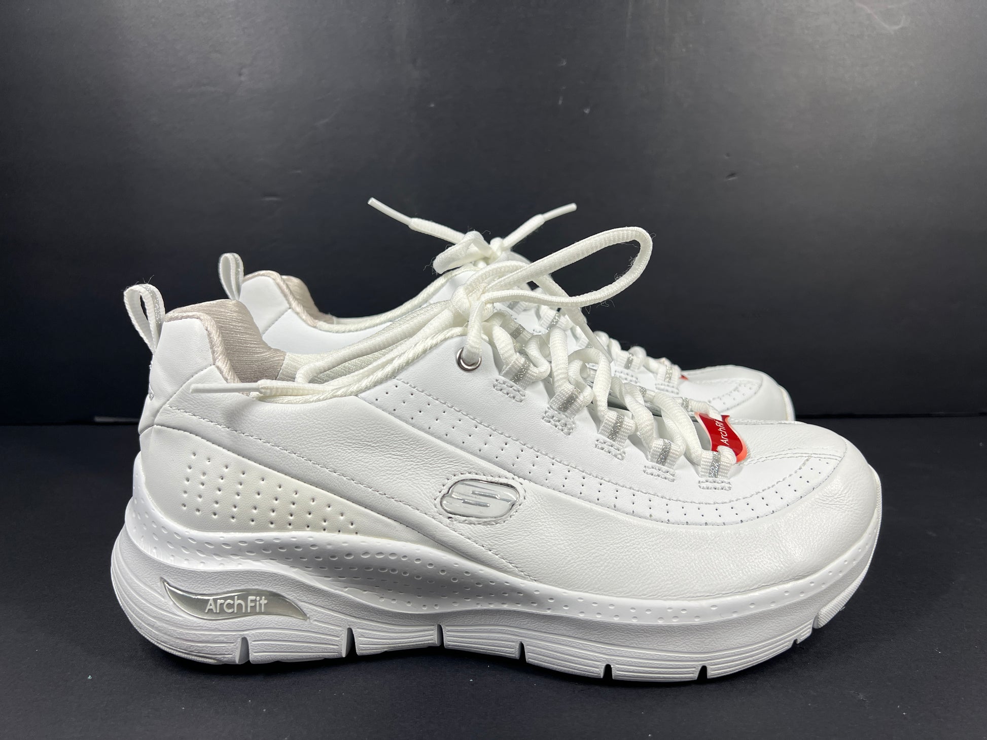A pair of white Skechers Arch Fit women's sneakers