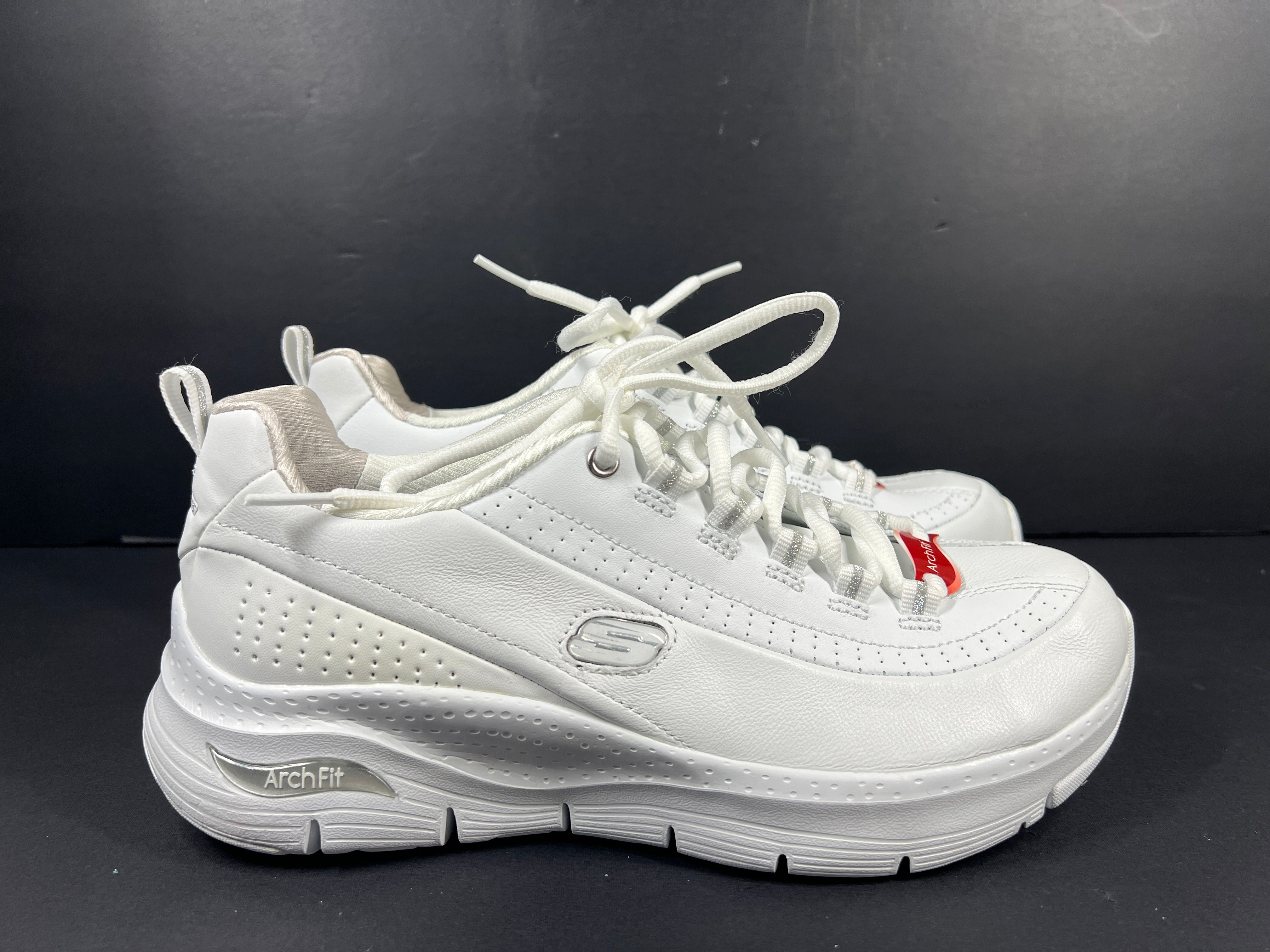 A pair of white Skechers Arch Fit women's sneakers