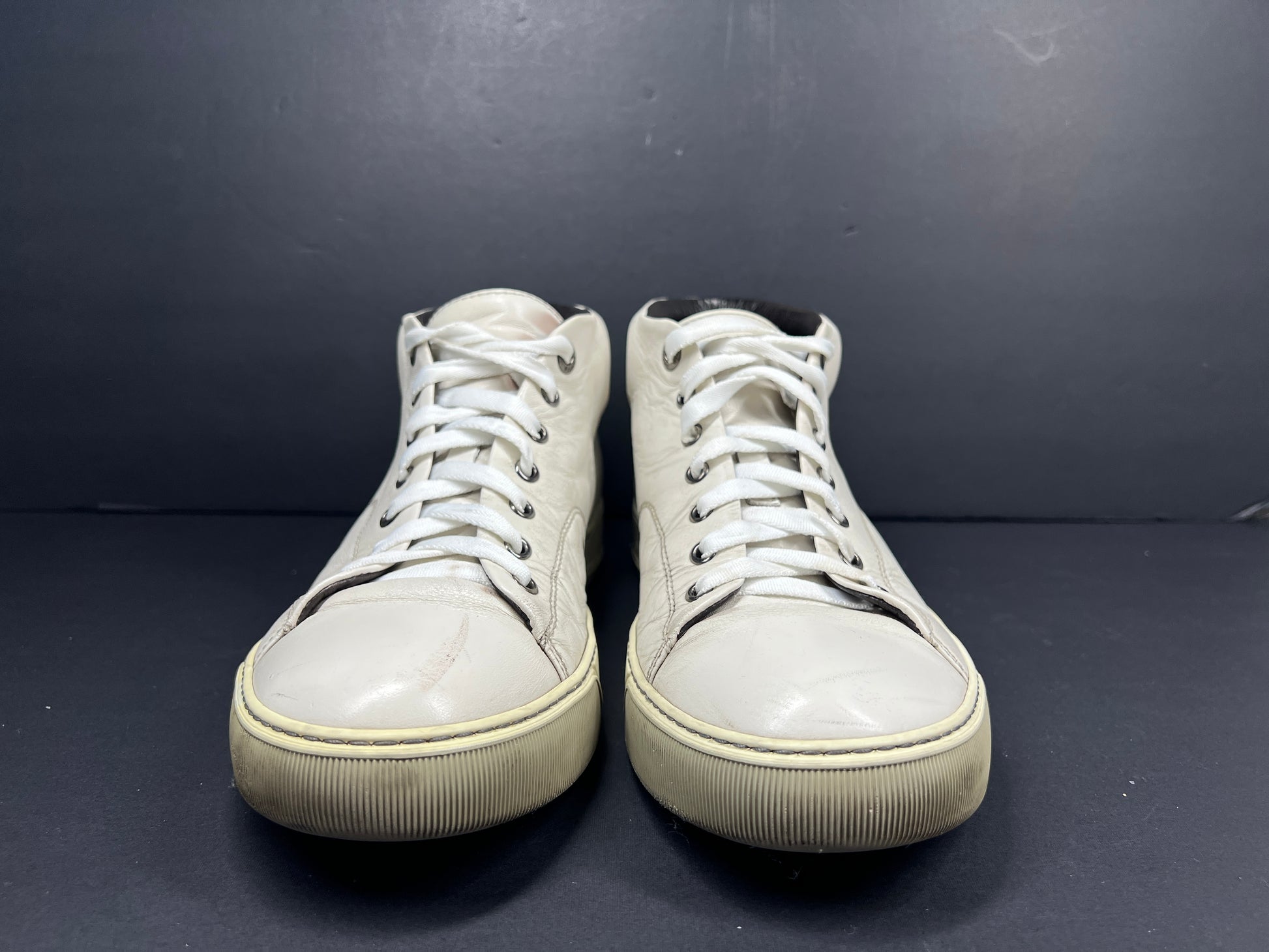 A pair of white leather high-top sneakers by Lanvin