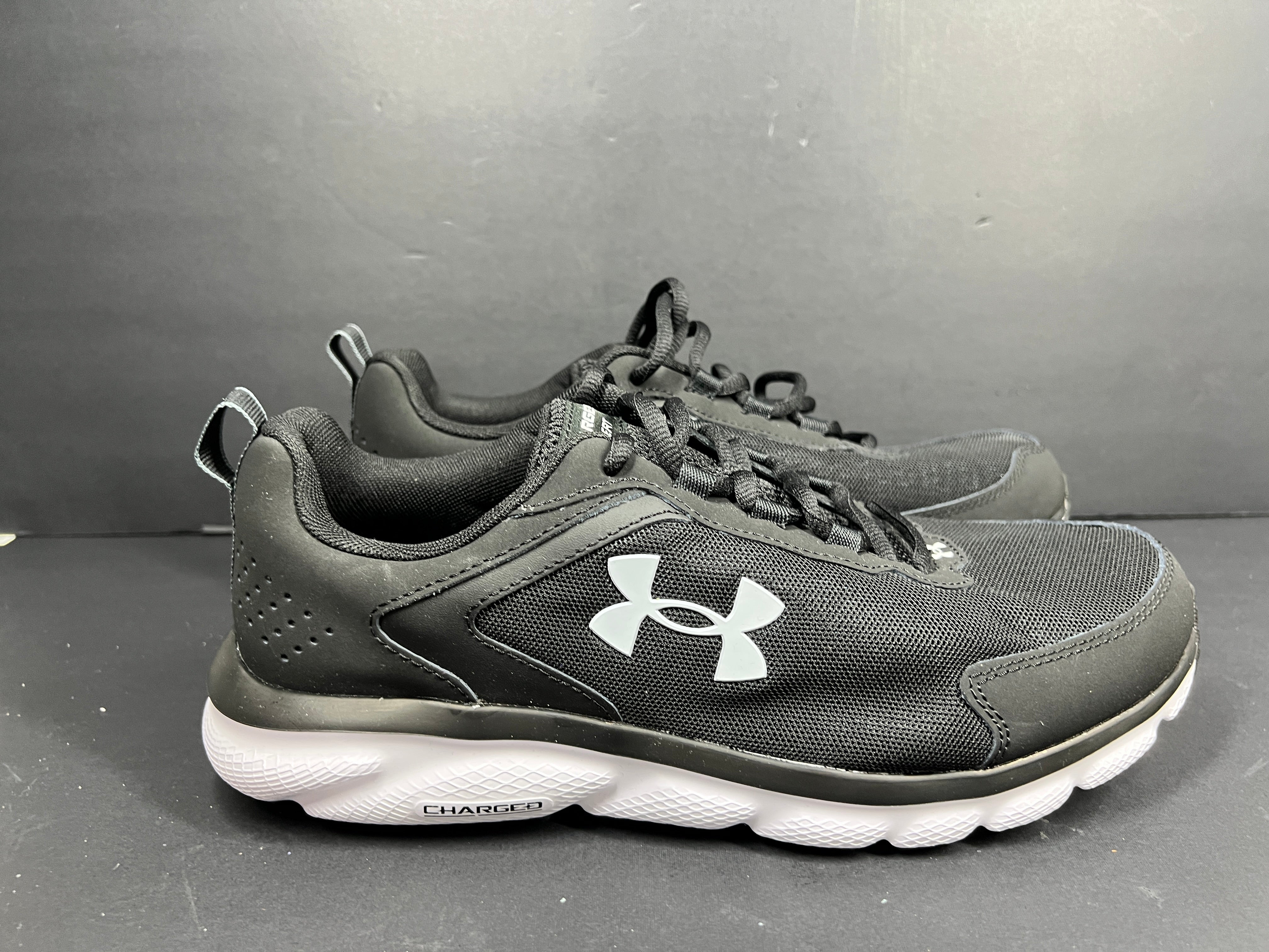 A pair of black Under Armour Charged Assert 9 running shoes for men