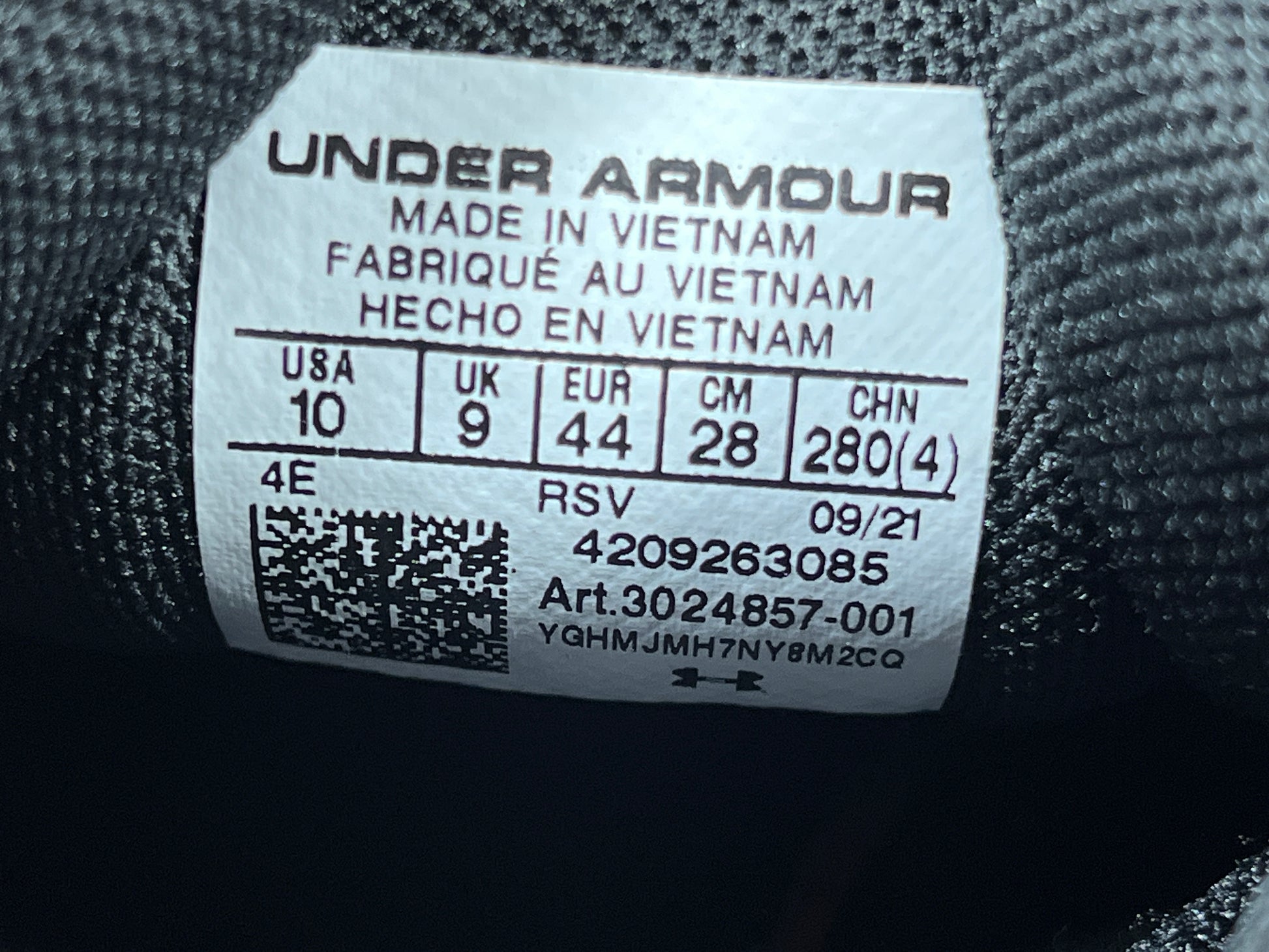 A pair of black Under Armour Charged Assert 9 running shoes for men