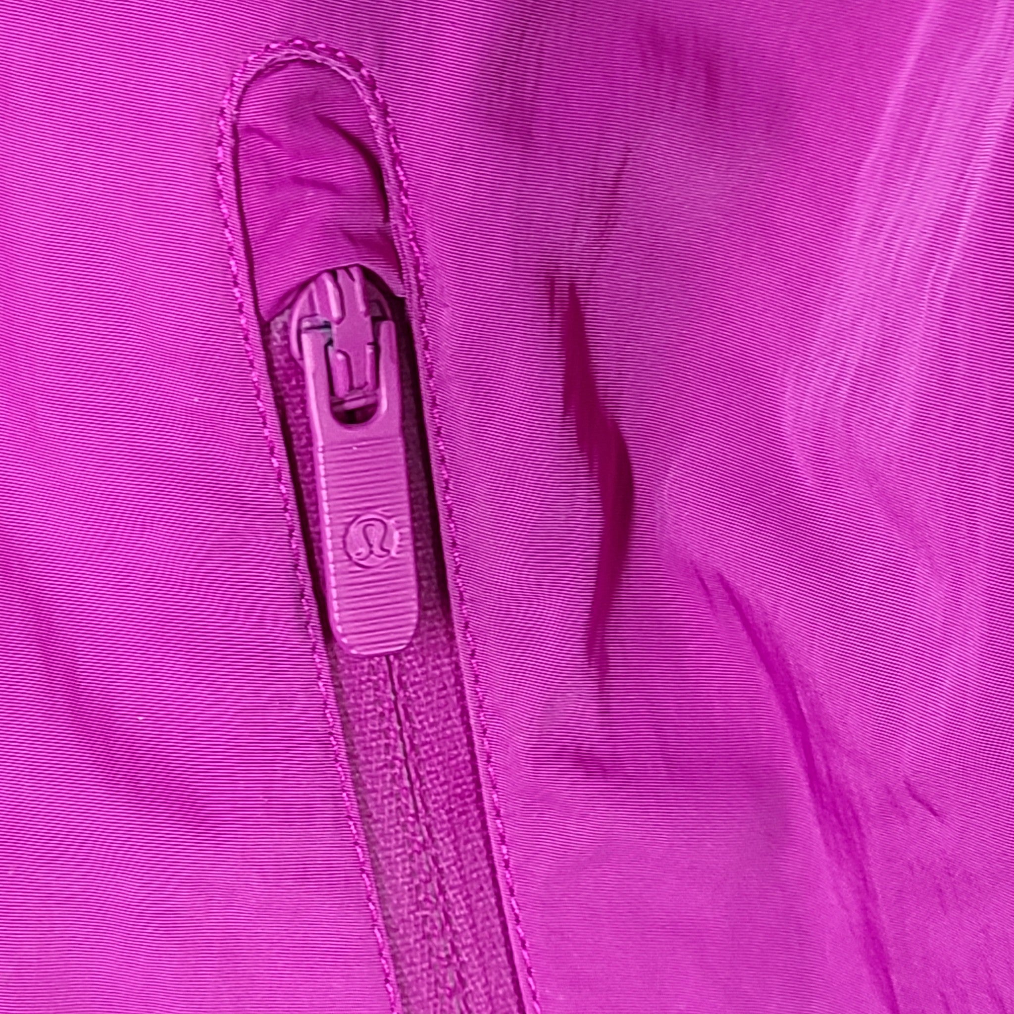 A stylish pink hooded jacket made of recycled materials