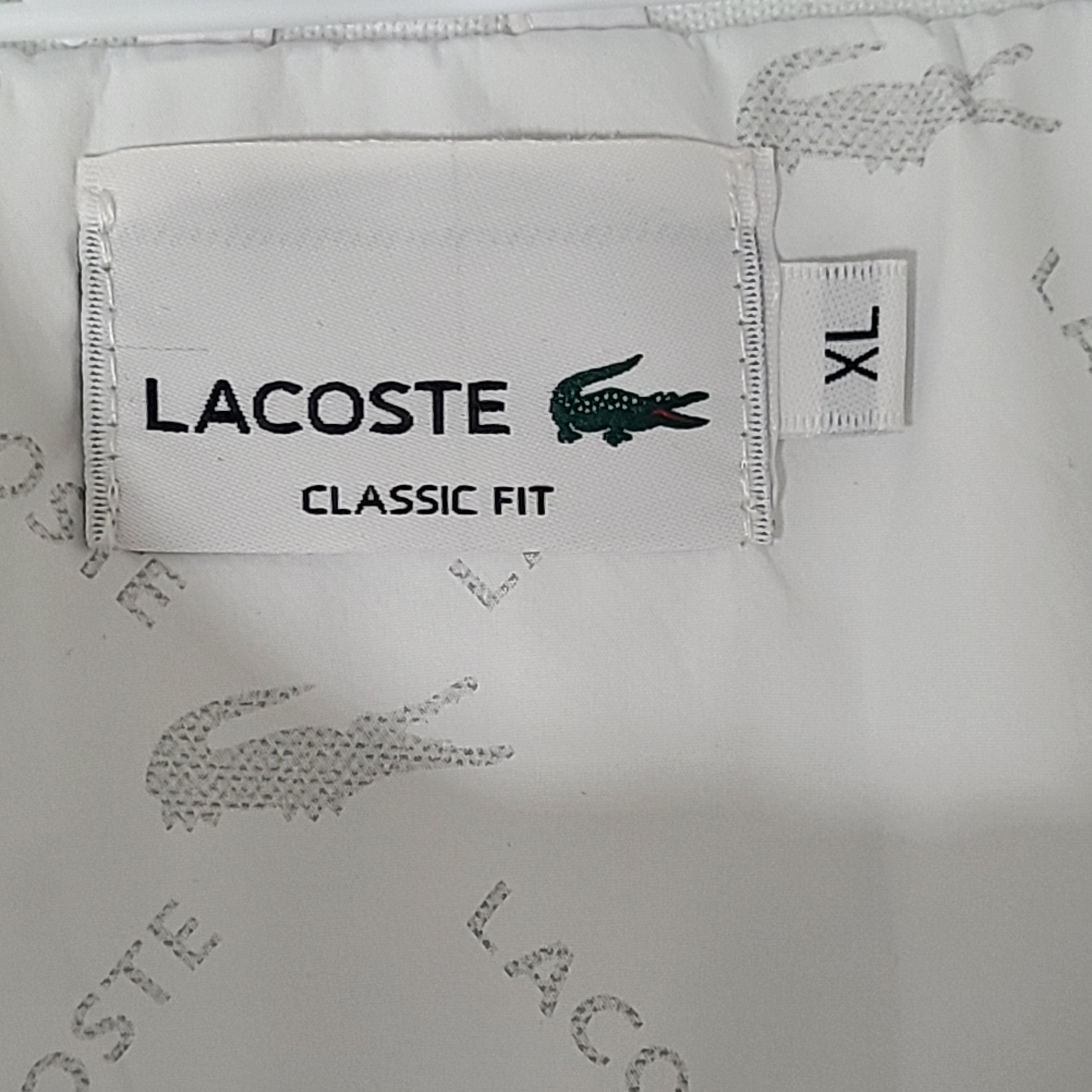 A stylish white Lacoste jacket for men in XL size.
