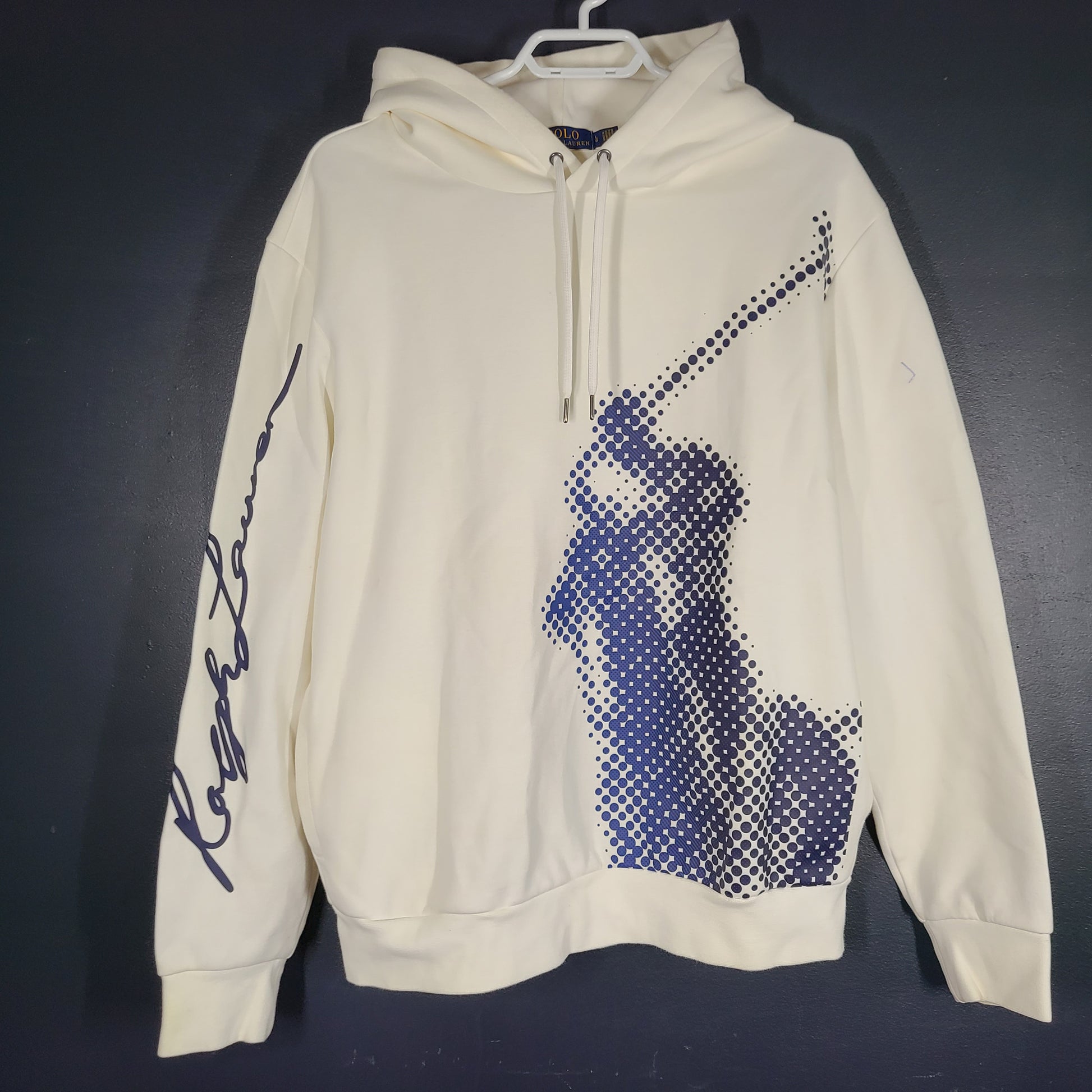 A cream men's hoodie with blue graphic by Polo Ralph Lauren