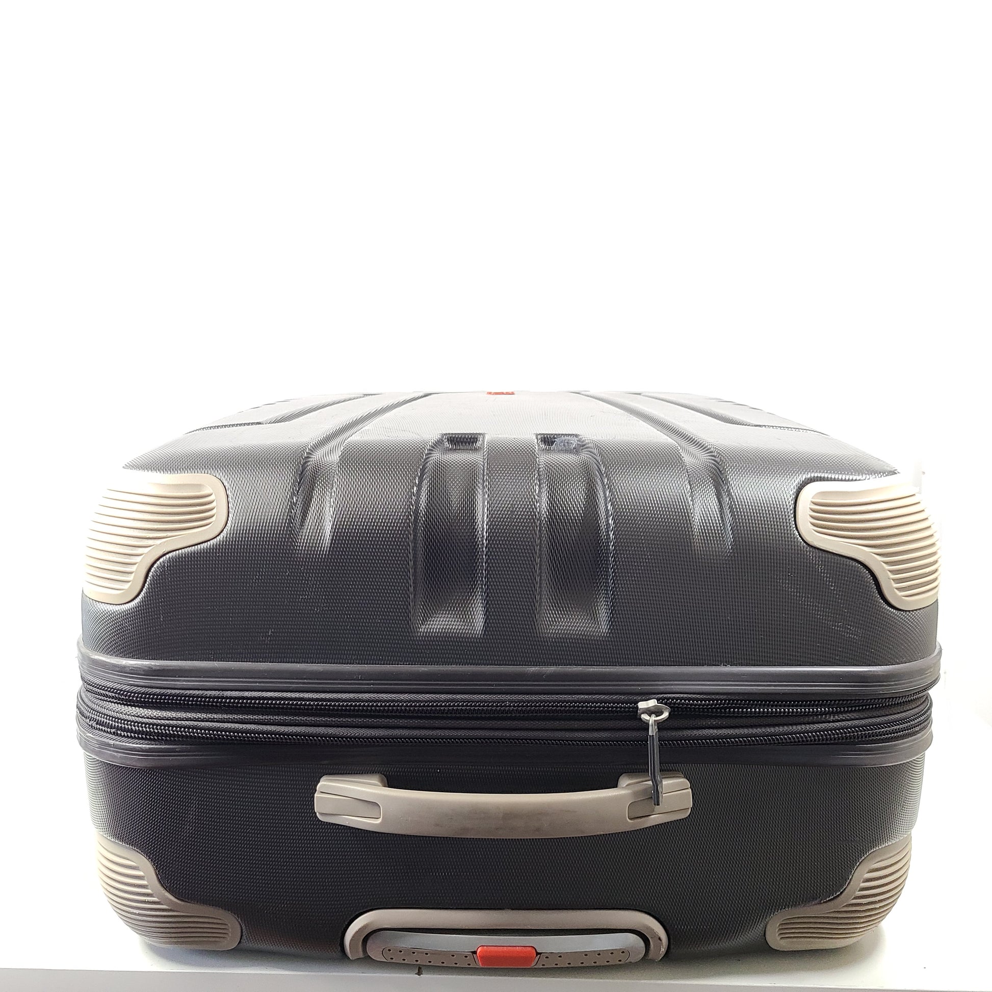 A red hard shell spinner suitcase by it Luggage