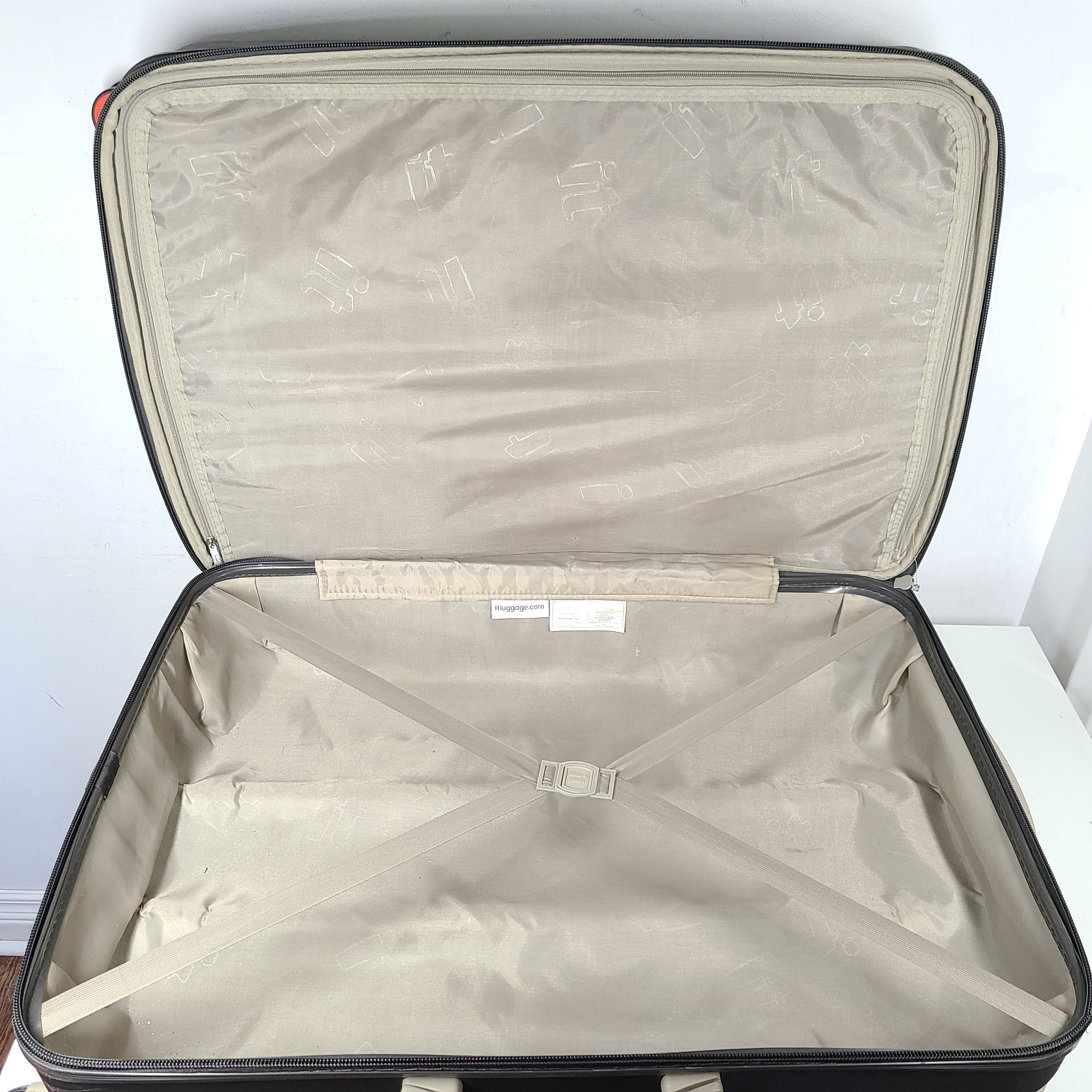 A red hard shell spinner suitcase by it Luggage