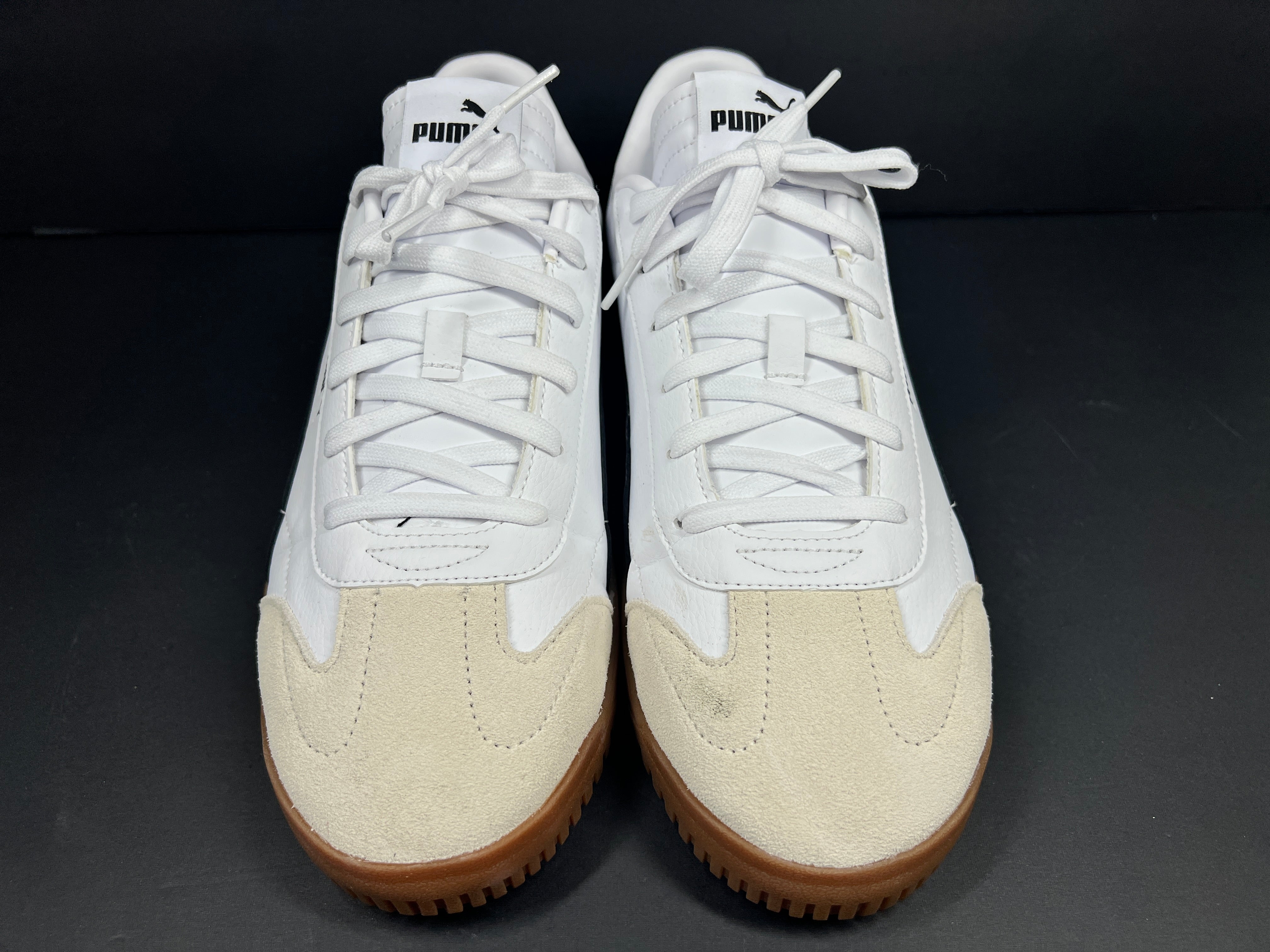 A pair of stylish white and black Puma Men's Sneakers in suede material