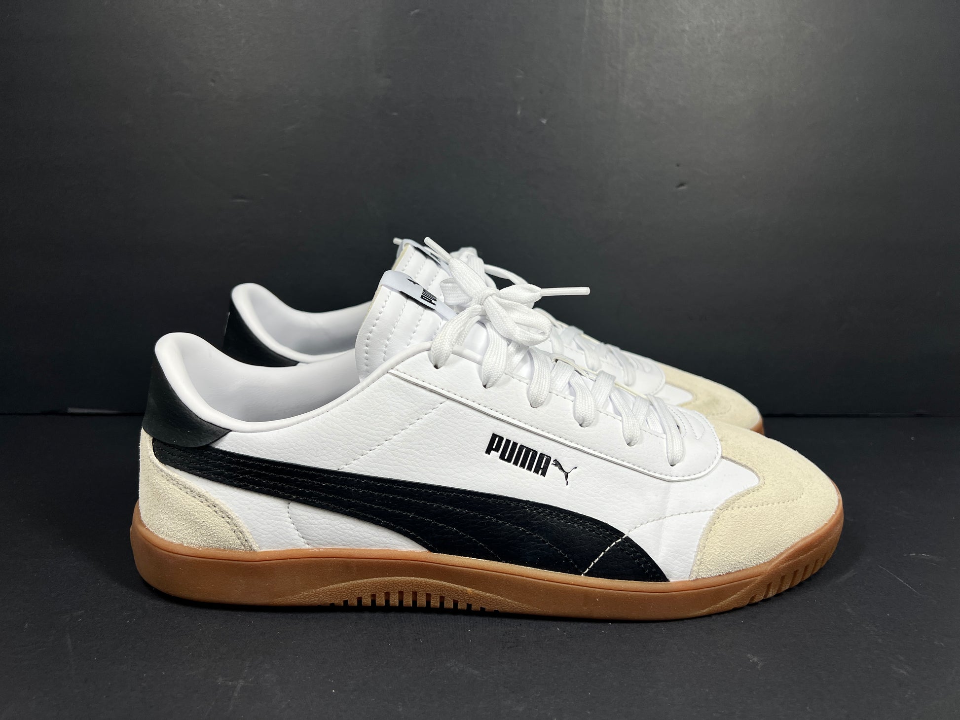 A pair of stylish white and black Puma Men's Sneakers in suede material