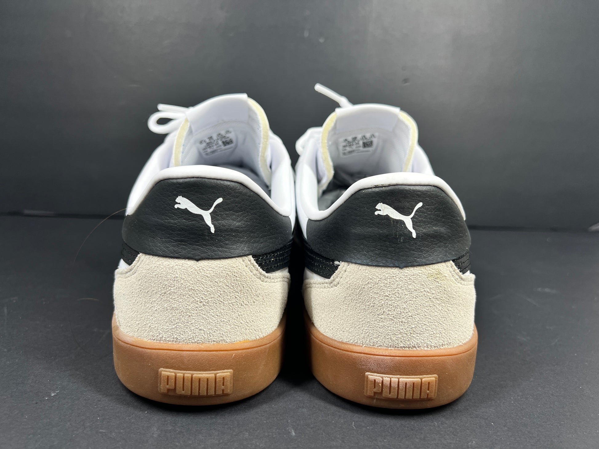A pair of stylish white and black Puma Men's Sneakers in suede material