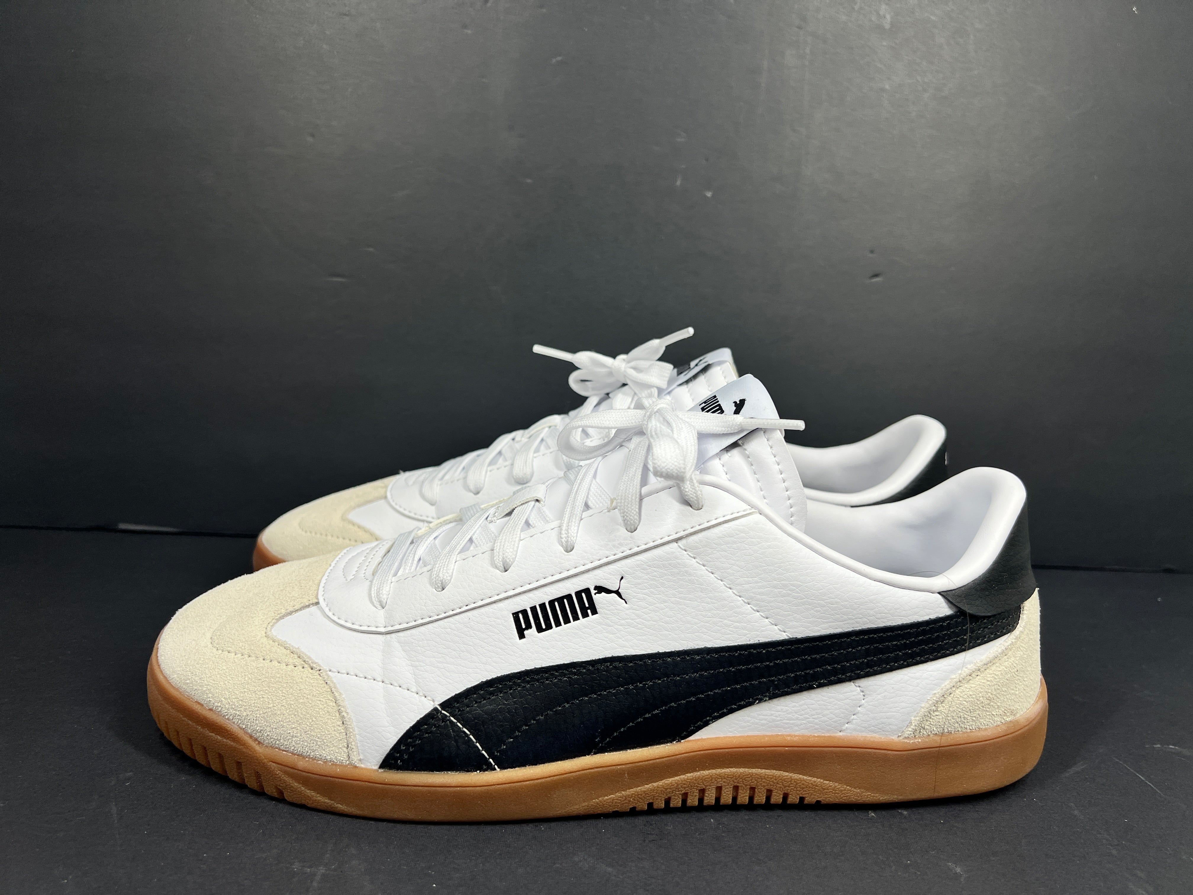 A pair of stylish white and black Puma Men's Sneakers in suede material