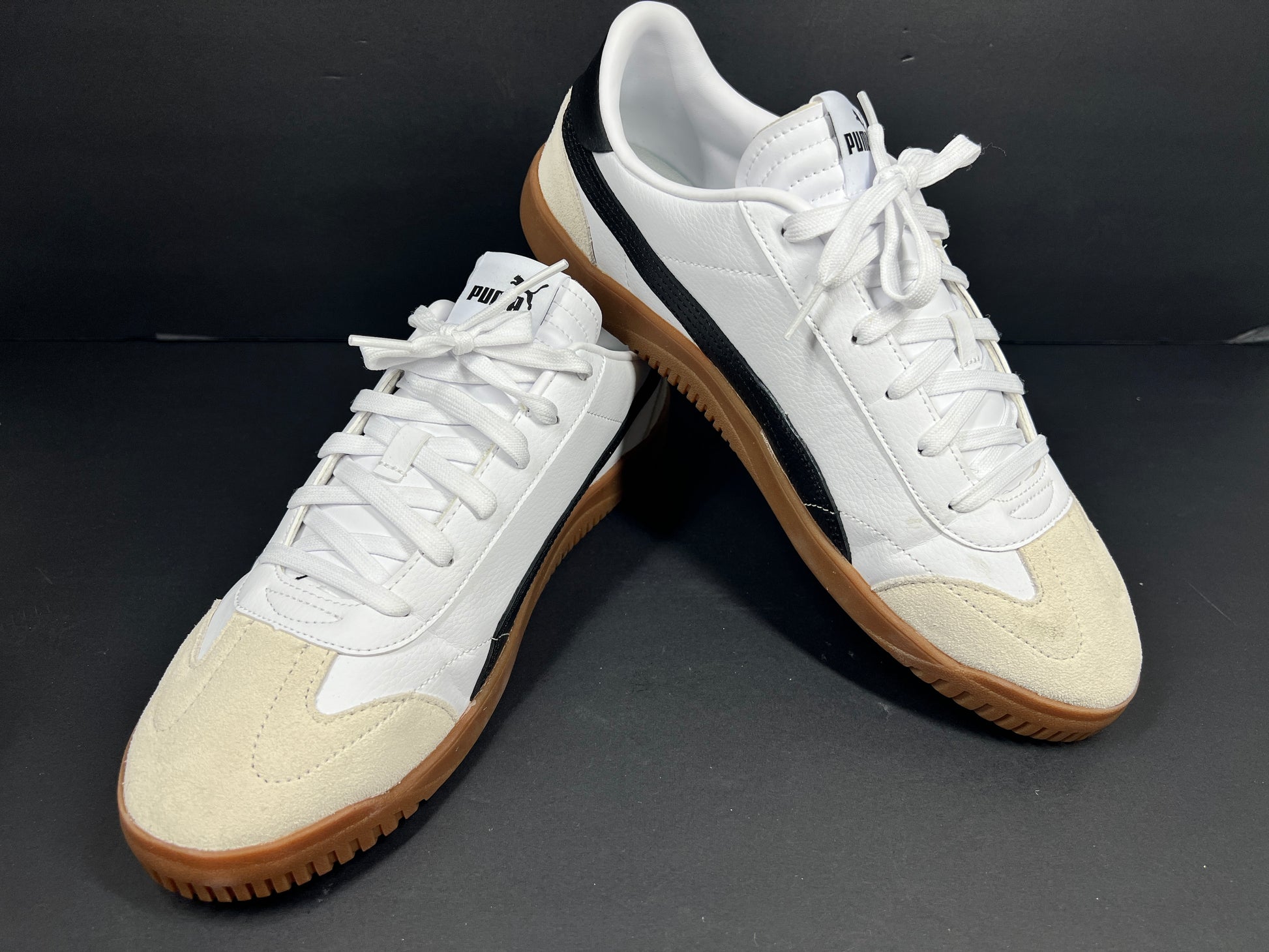 A pair of stylish white and black Puma Men's Sneakers in suede material