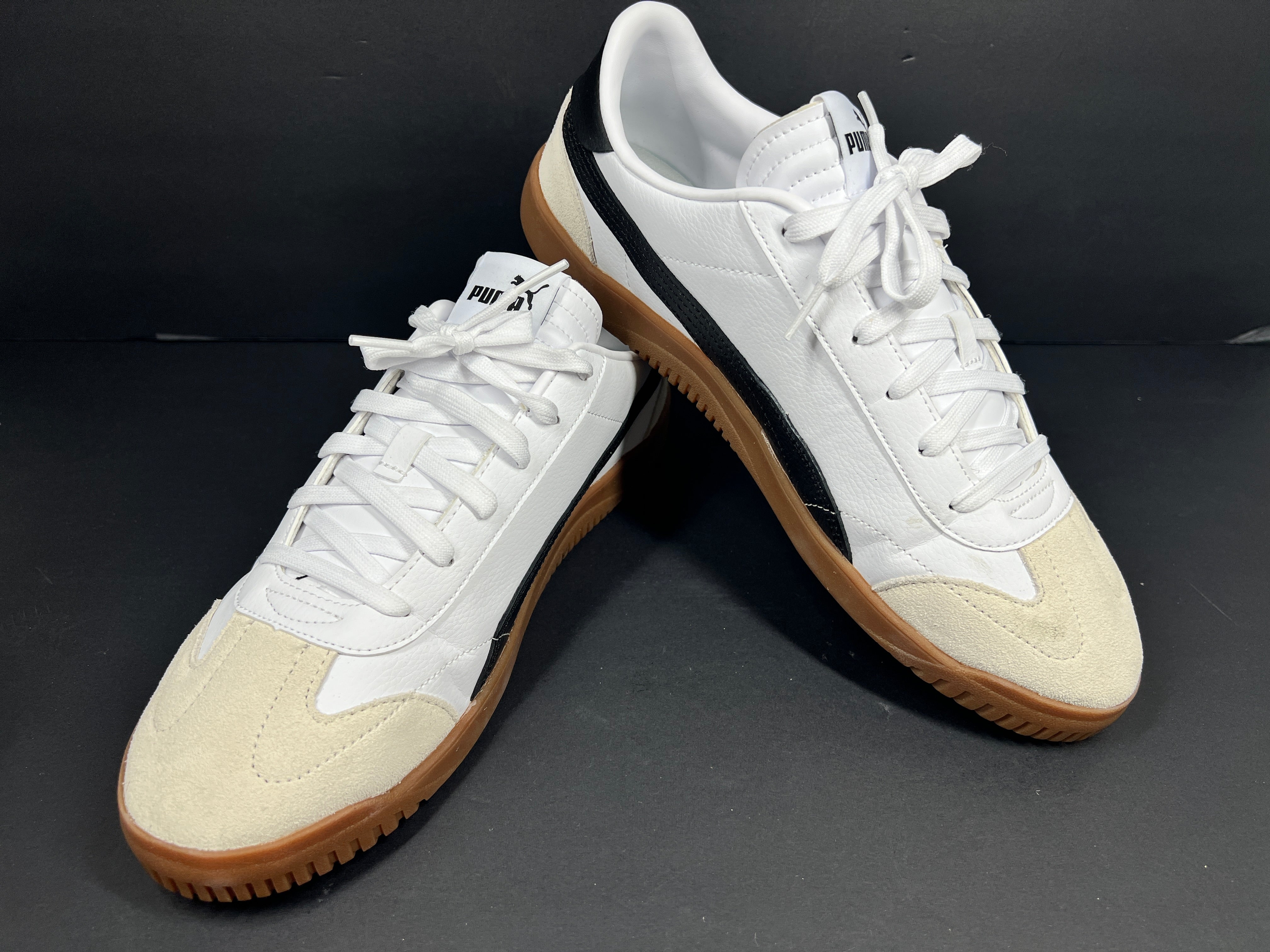 A pair of stylish white and black Puma Men's Sneakers in suede material