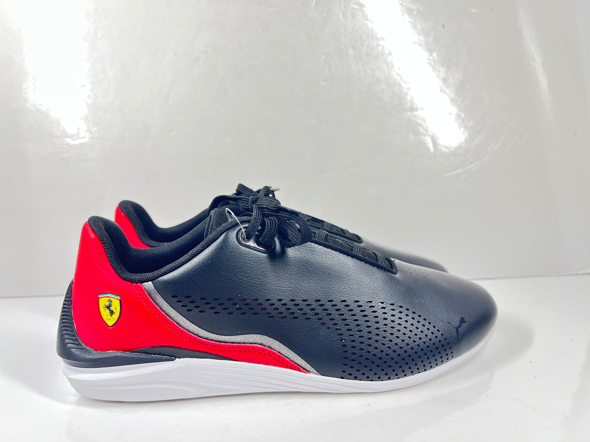 A pair of black and red Puma Scuderia Ferrari Kart Cat III shoes