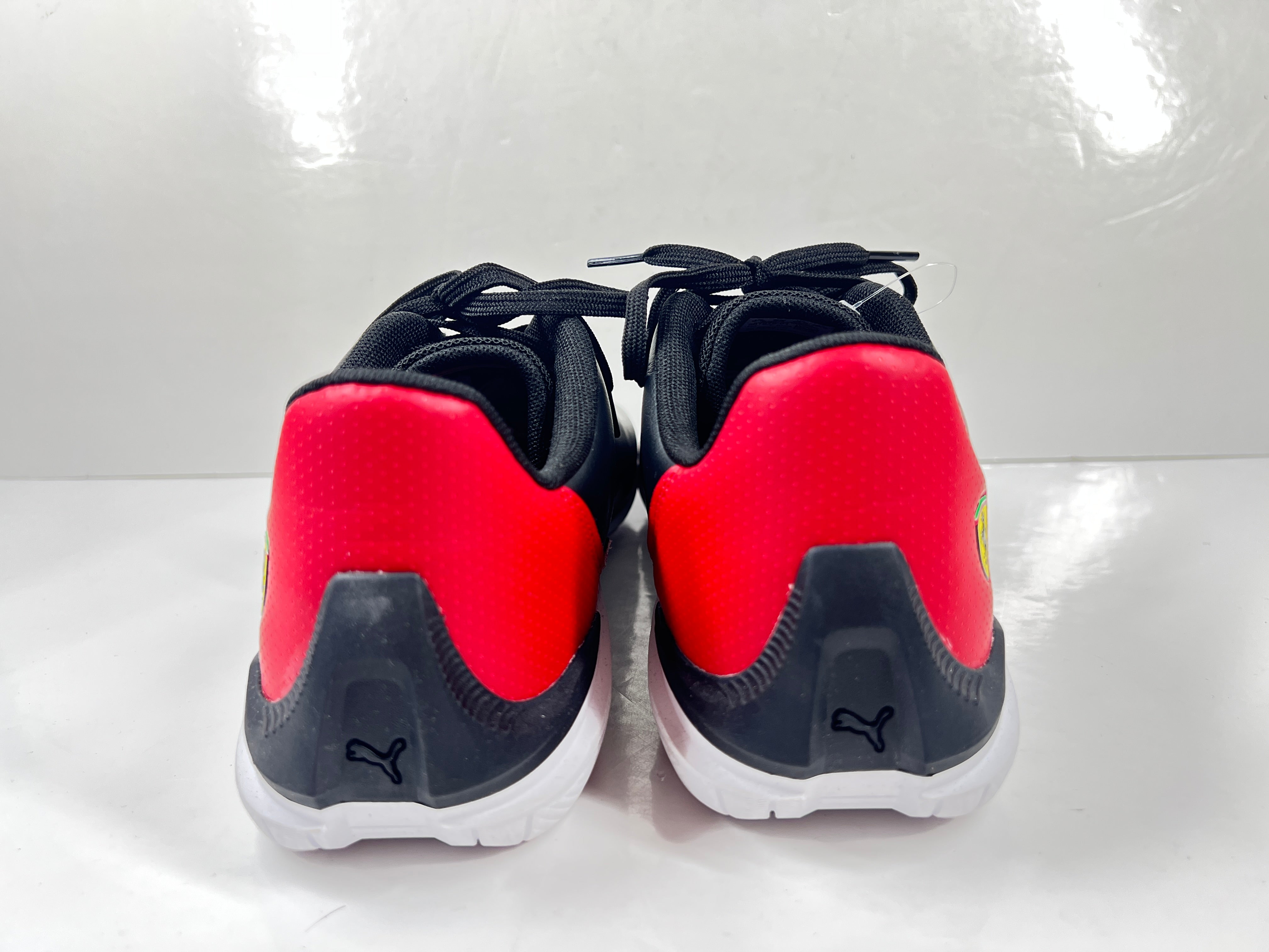 A pair of black and red Puma Scuderia Ferrari Kart Cat III shoes