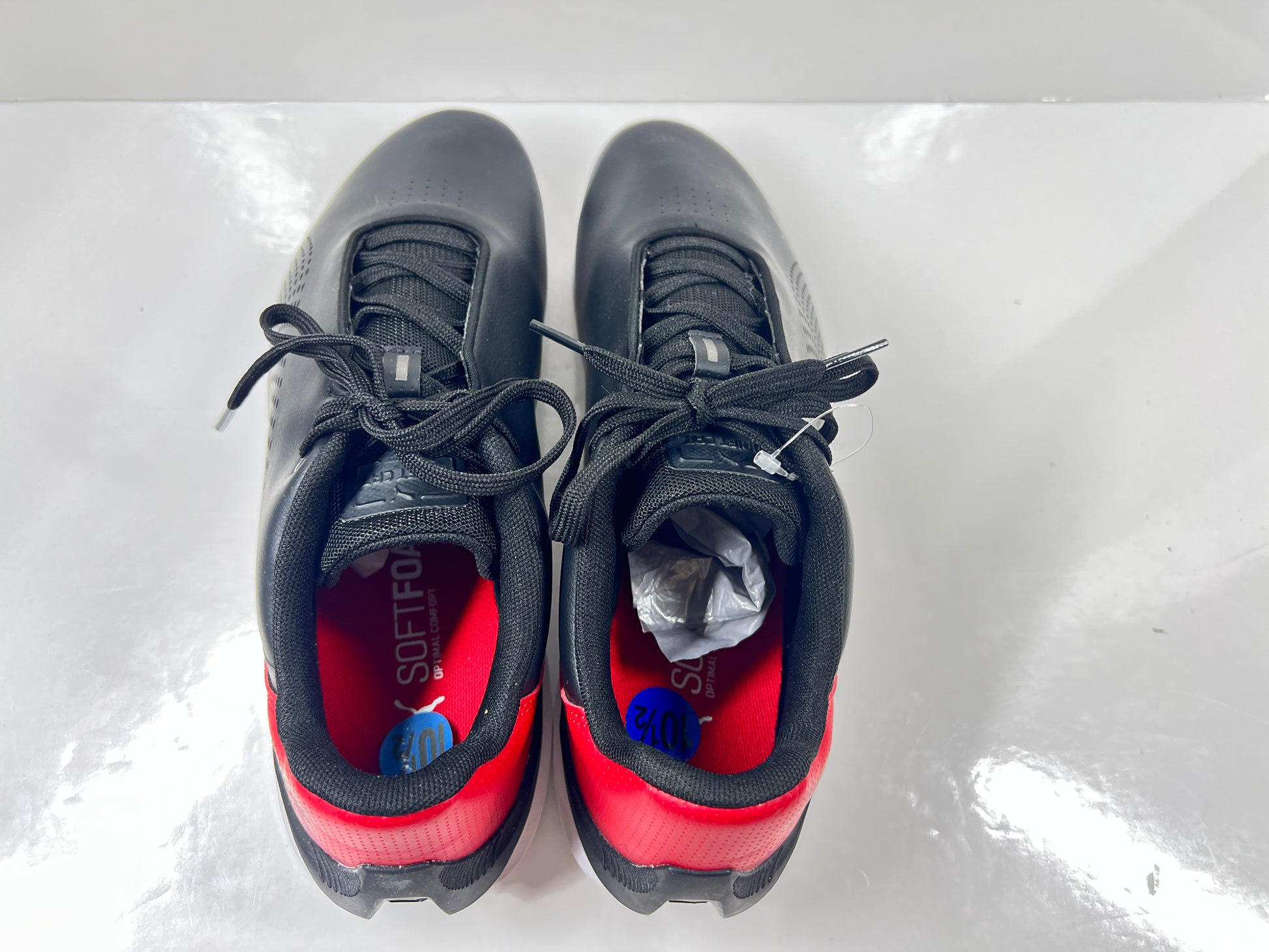 A pair of black and red Puma Scuderia Ferrari Kart Cat III shoes