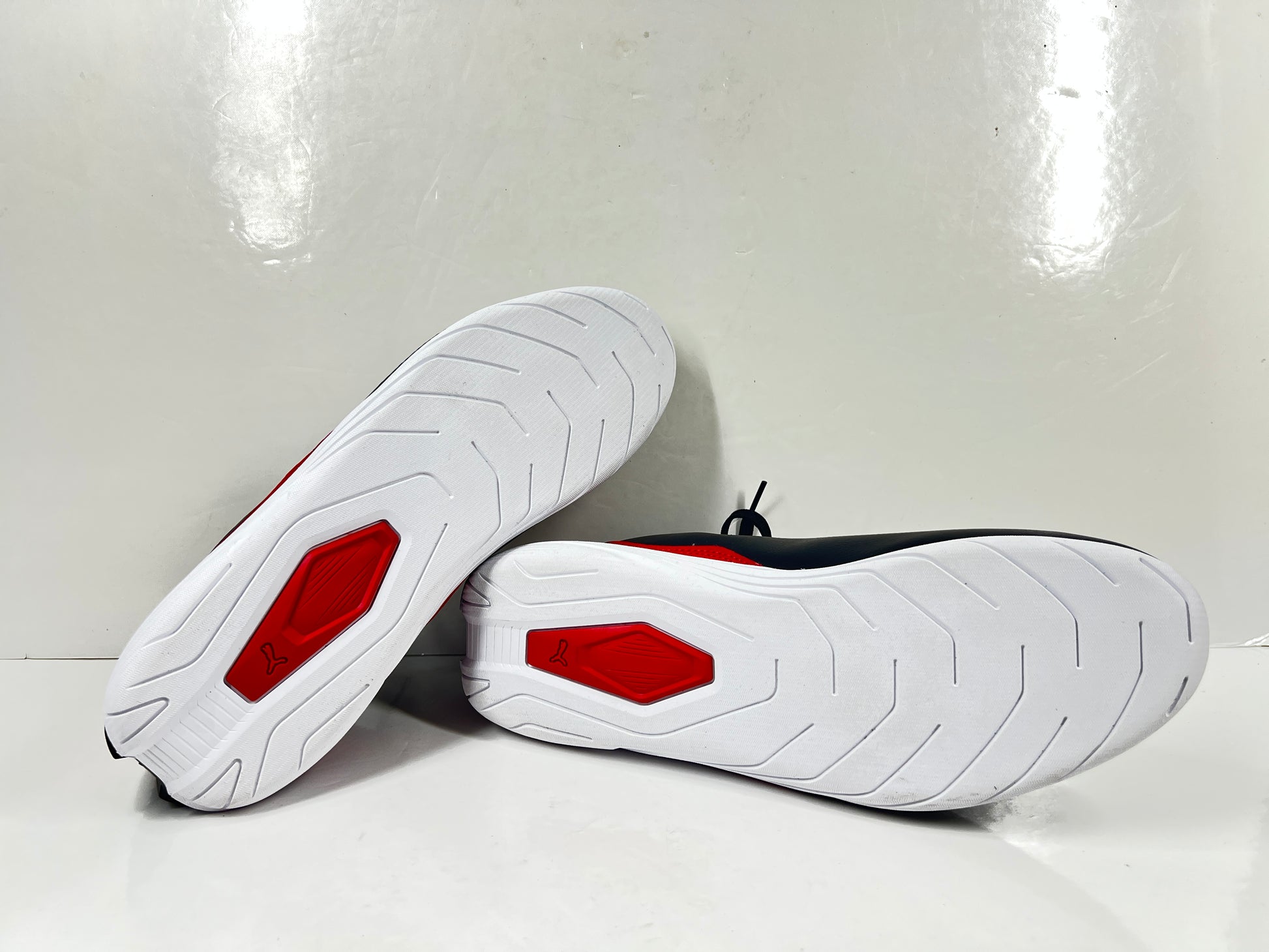 A pair of black and red Puma Scuderia Ferrari Kart Cat III shoes