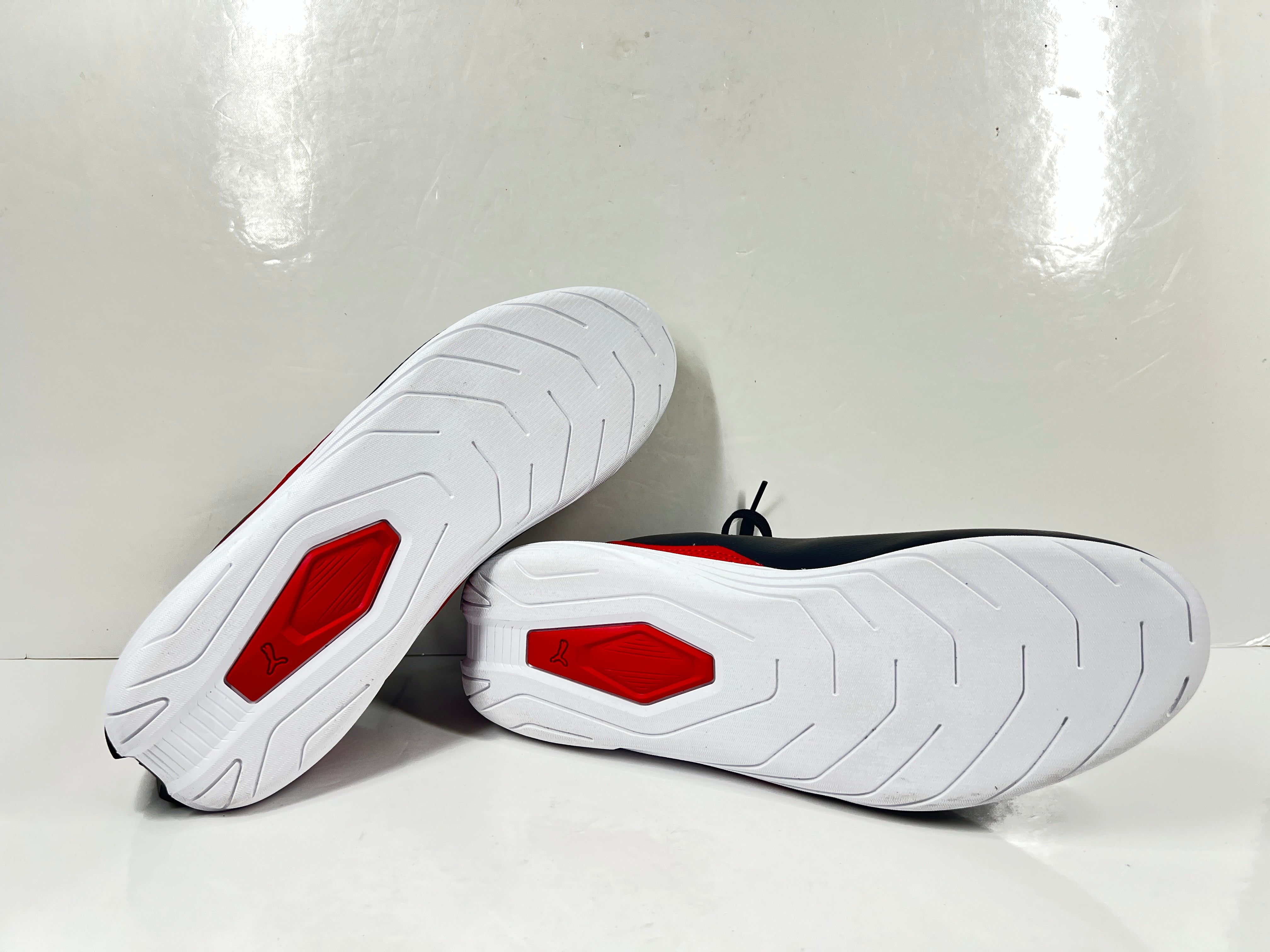 A pair of black and red Puma Scuderia Ferrari Kart Cat III shoes