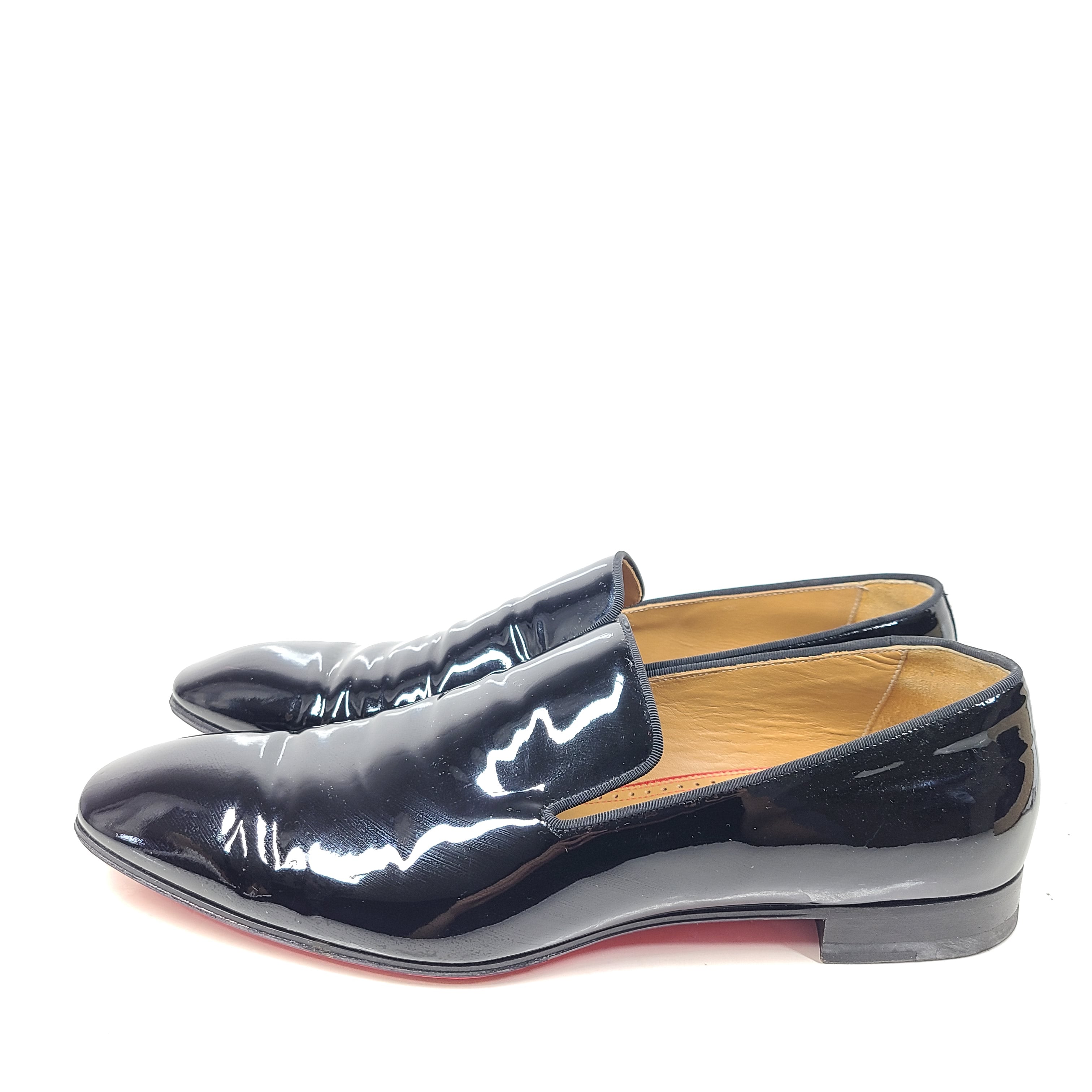 A pair of black patent leather loafers by Christian Louboutin