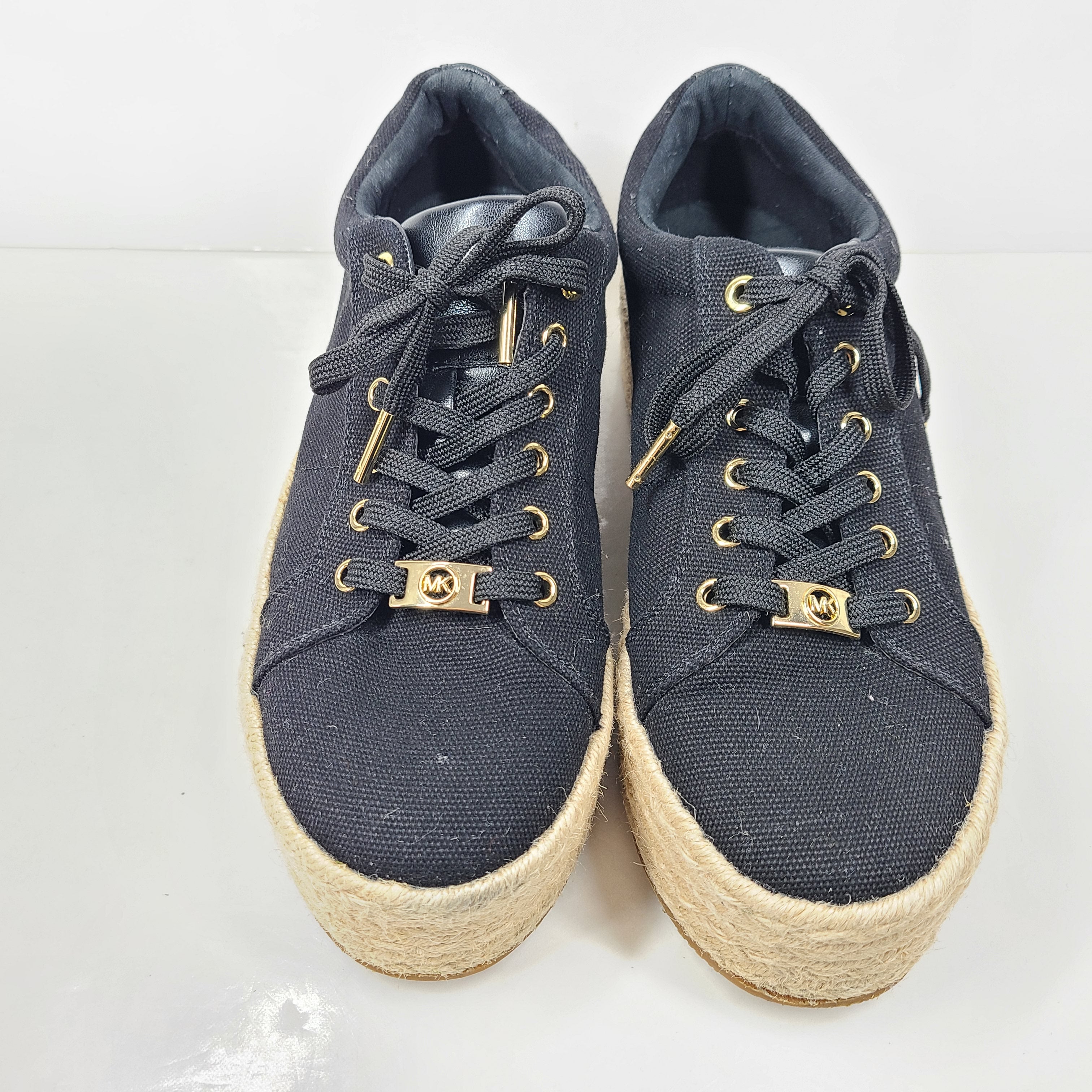 A pair of Michael Kors Women's Platform Sneakers in Black and Gold