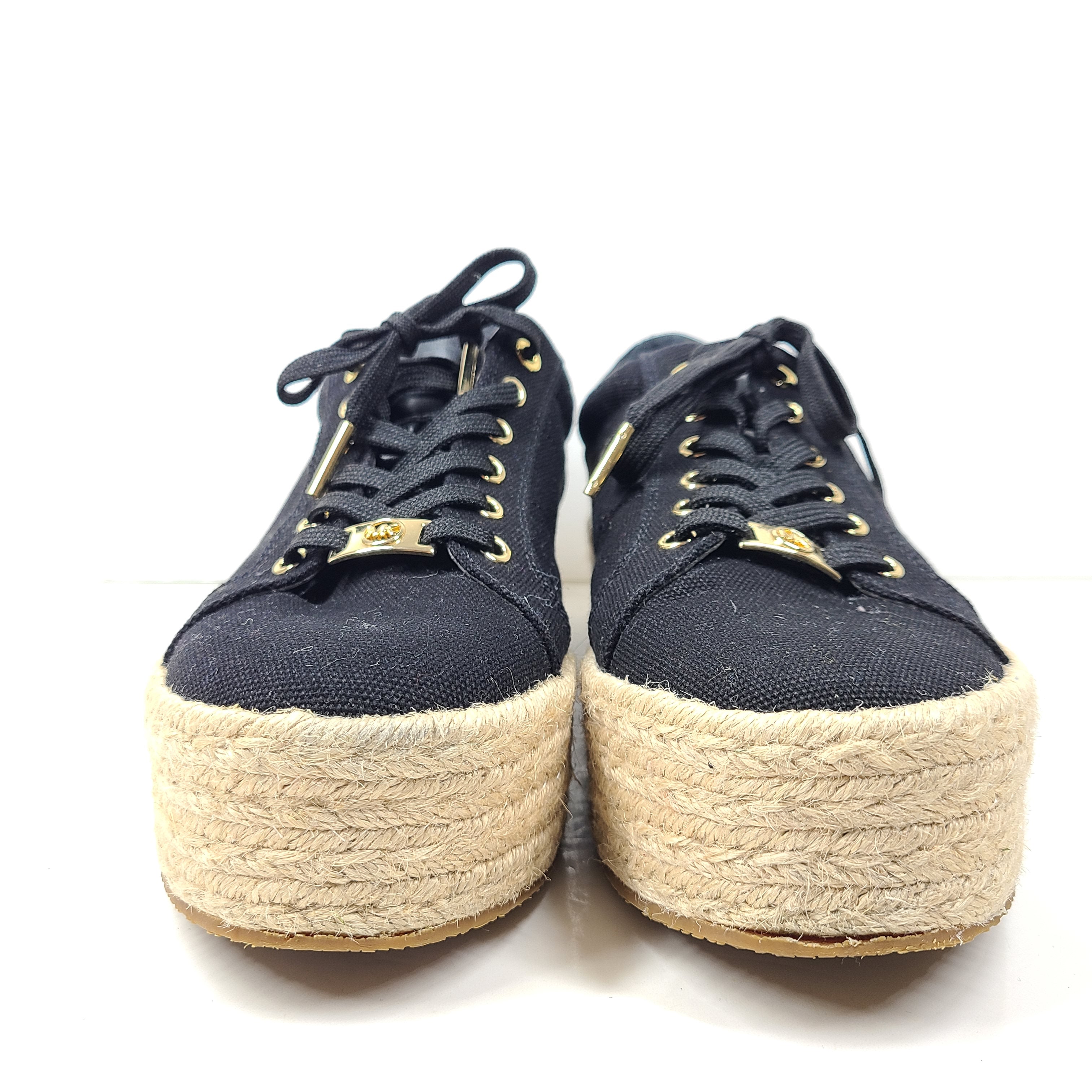 A pair of Michael Kors Women's Platform Sneakers in Black and Gold