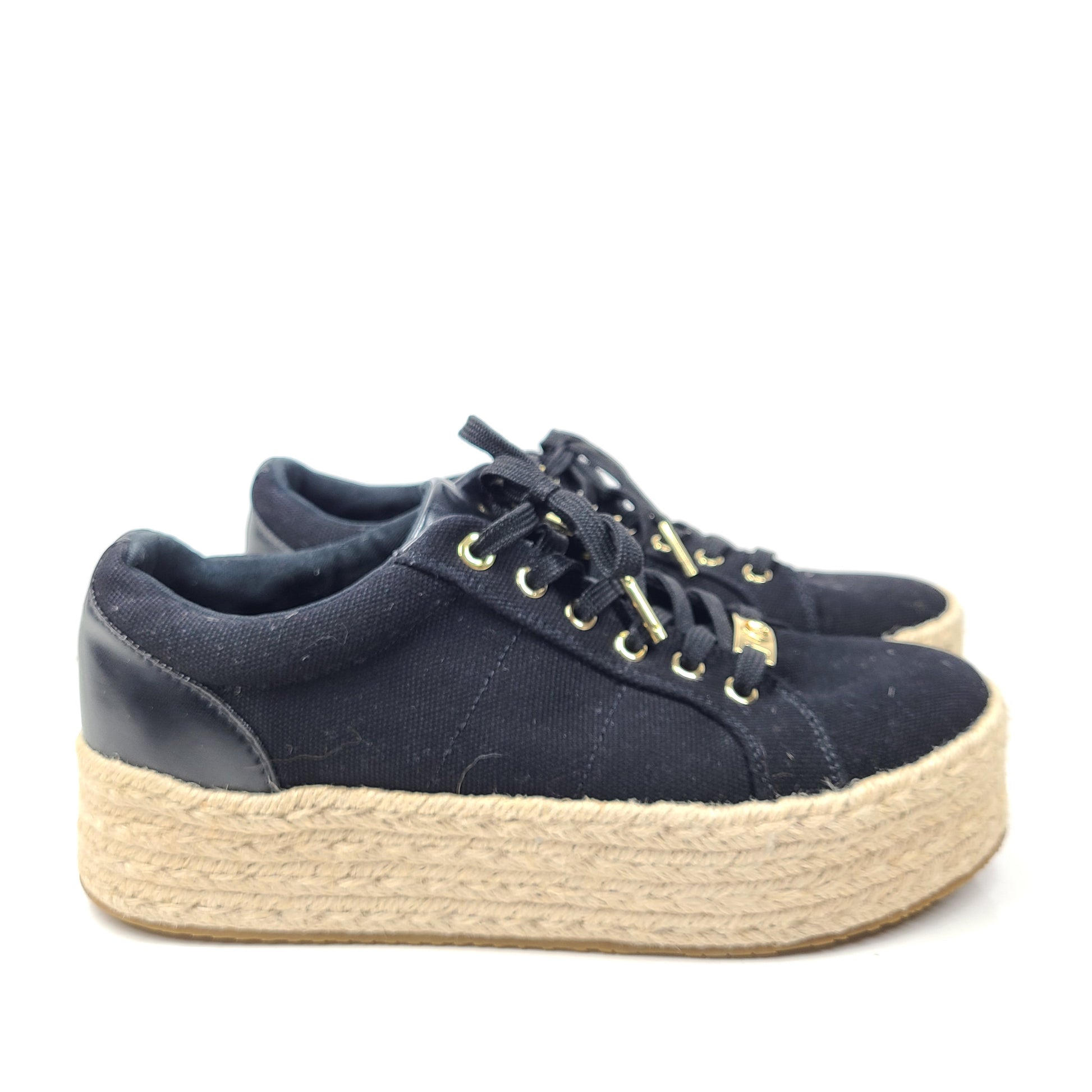 A pair of Michael Kors Women's Platform Sneakers in Black and Gold