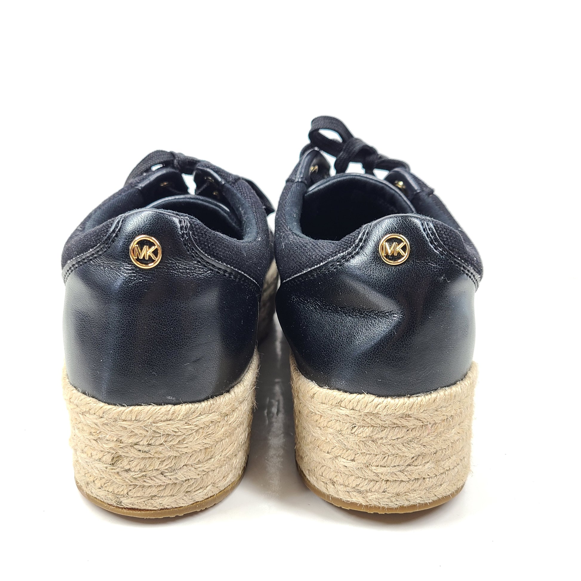 A pair of Michael Kors Women's Platform Sneakers in Black and Gold