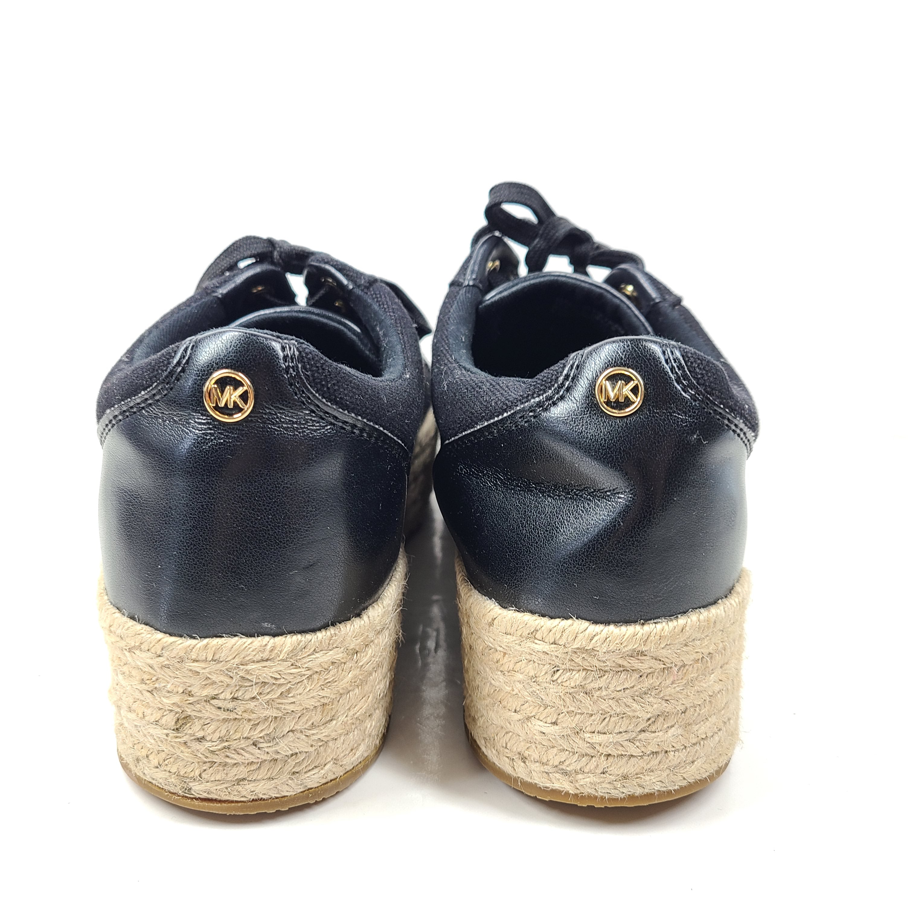 A pair of Michael Kors Women's Platform Sneakers in Black and Gold