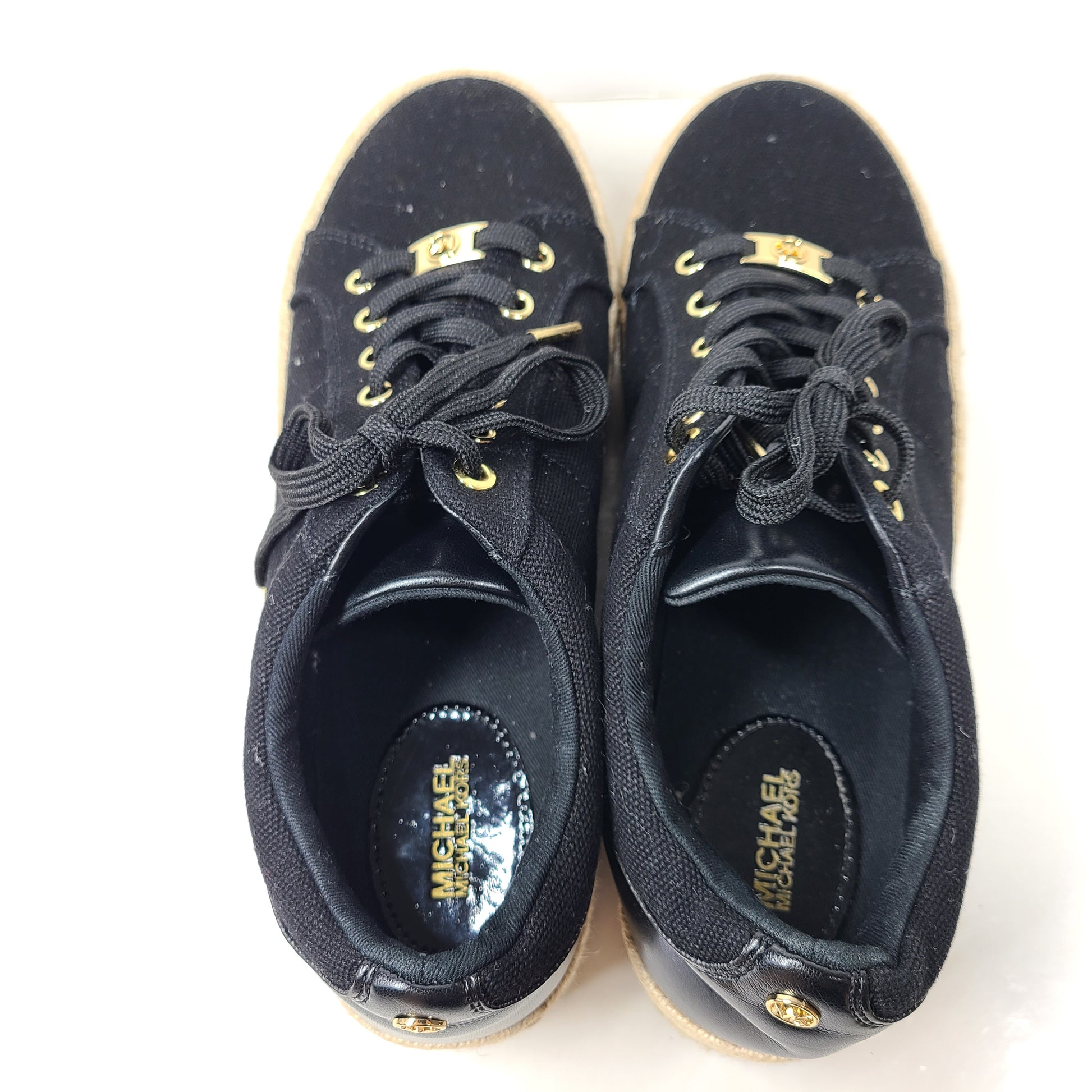 A pair of Michael Kors Women's Platform Sneakers in Black and Gold