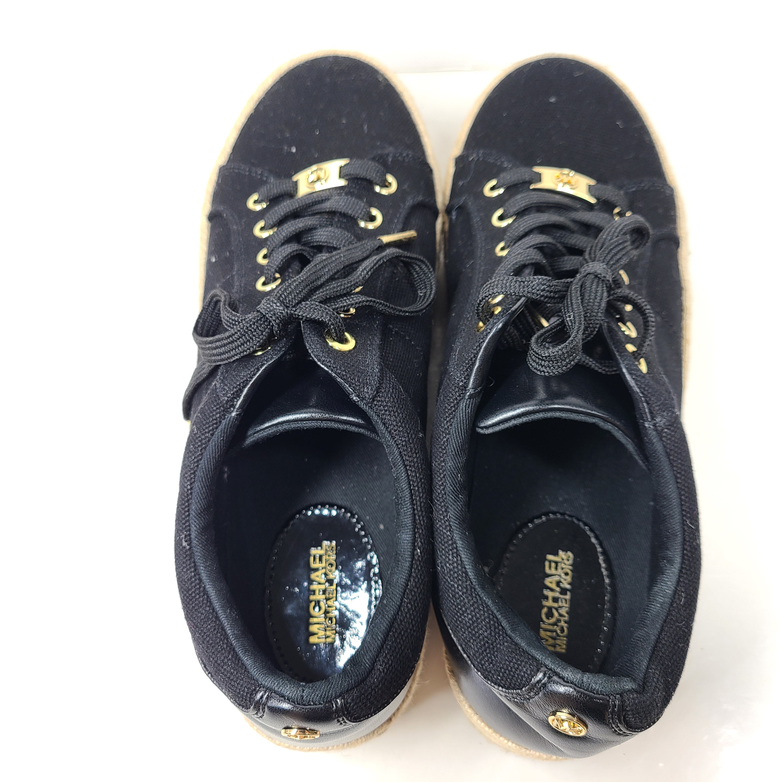 A pair of Michael Kors Women's Platform Sneakers in Black and Gold
