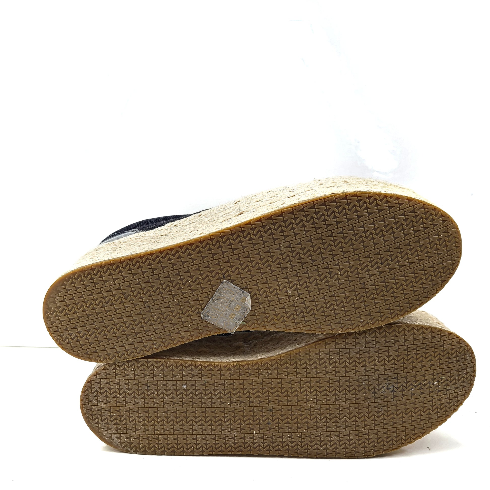 A pair of Michael Kors Women's Platform Sneakers in Black and Gold