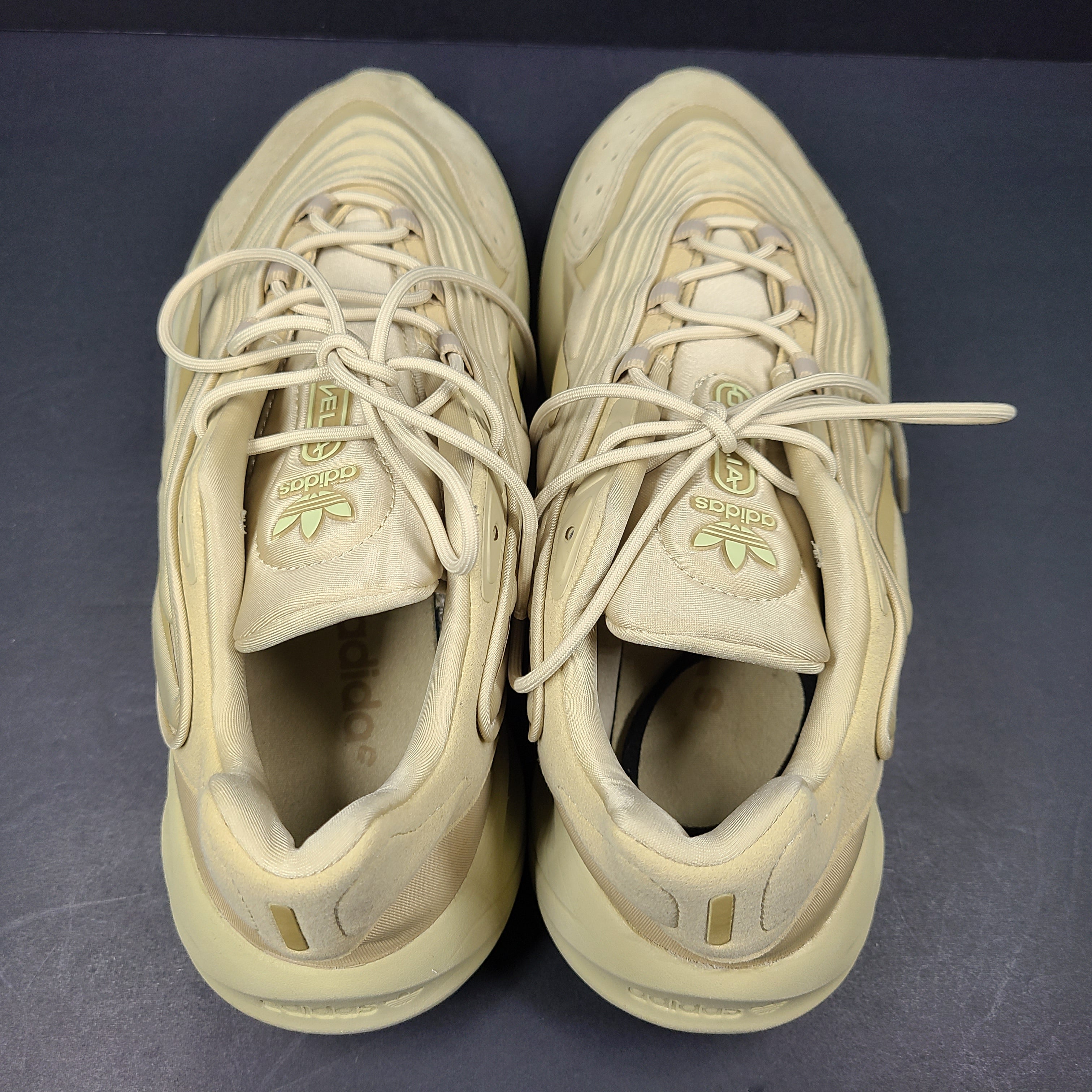 A pair of beige Adidas AdiPRENE GV7685 sneakers in size 10.