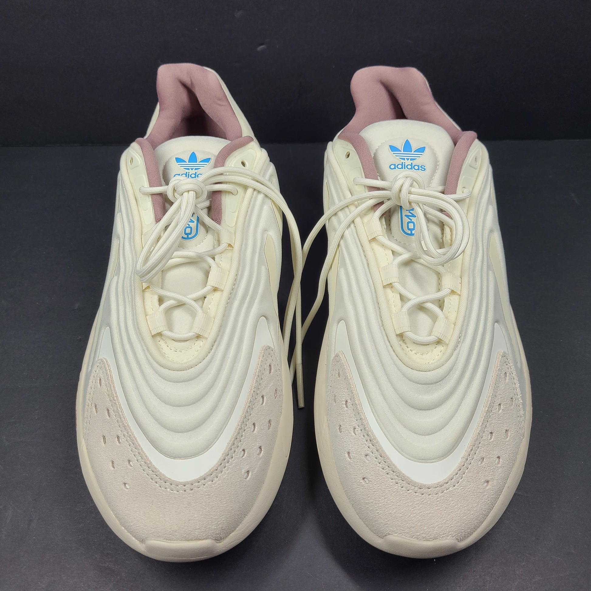 A pair of cream and blue Adidas adiPRENE sneakers in size 9.5 for men.