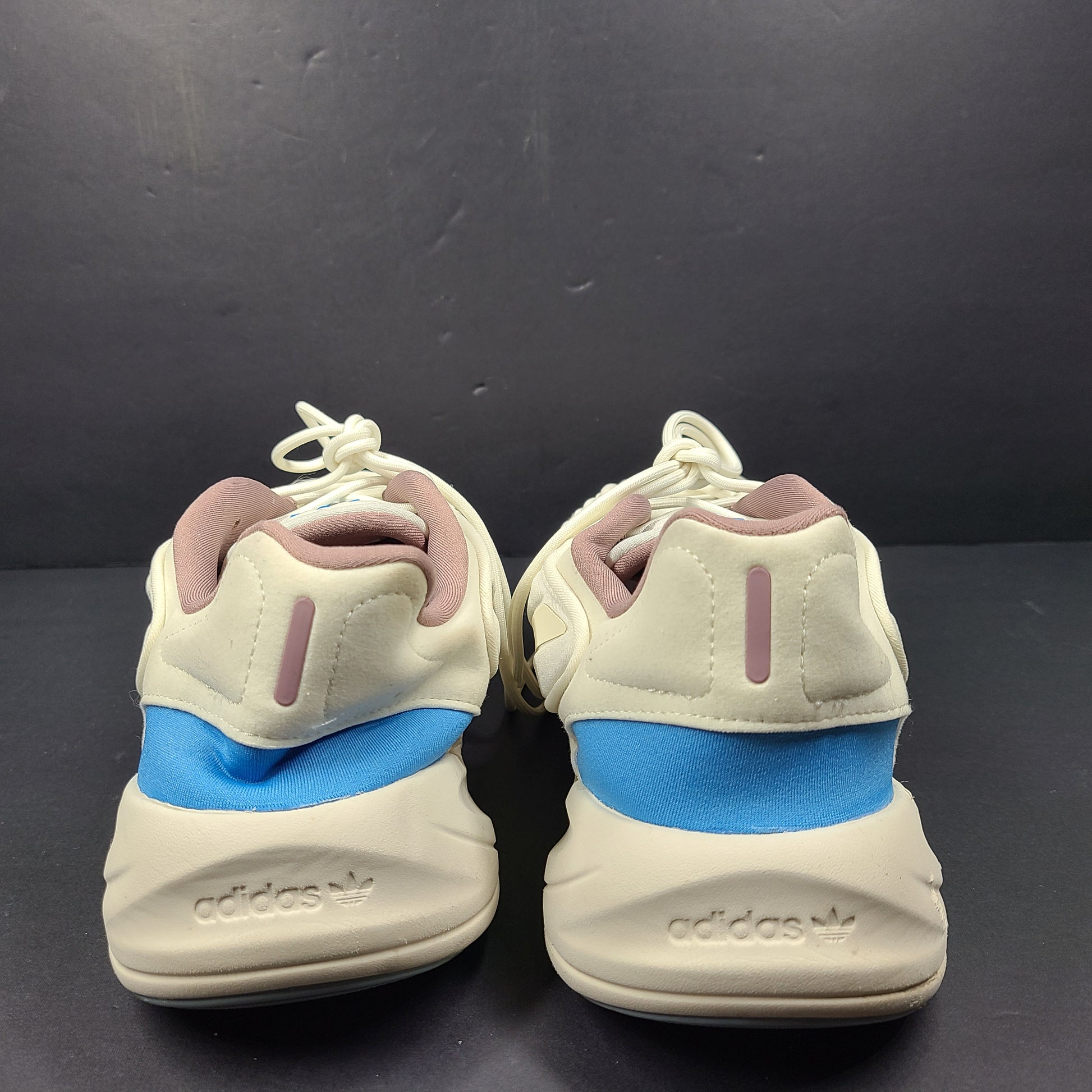 A pair of cream and blue Adidas adiPRENE sneakers in size 9.5 for men.