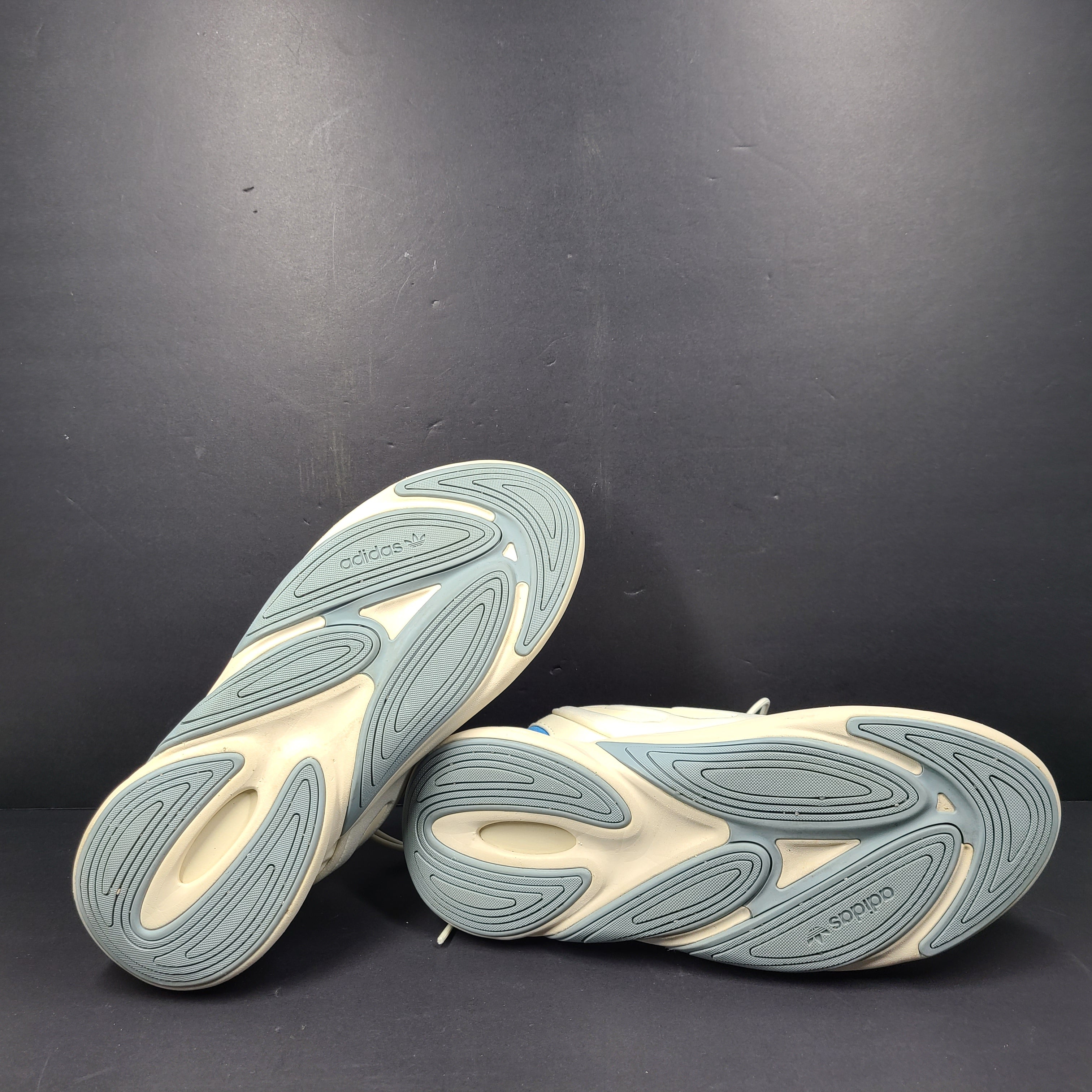A pair of cream and blue Adidas adiPRENE sneakers in size 9.5 for men.