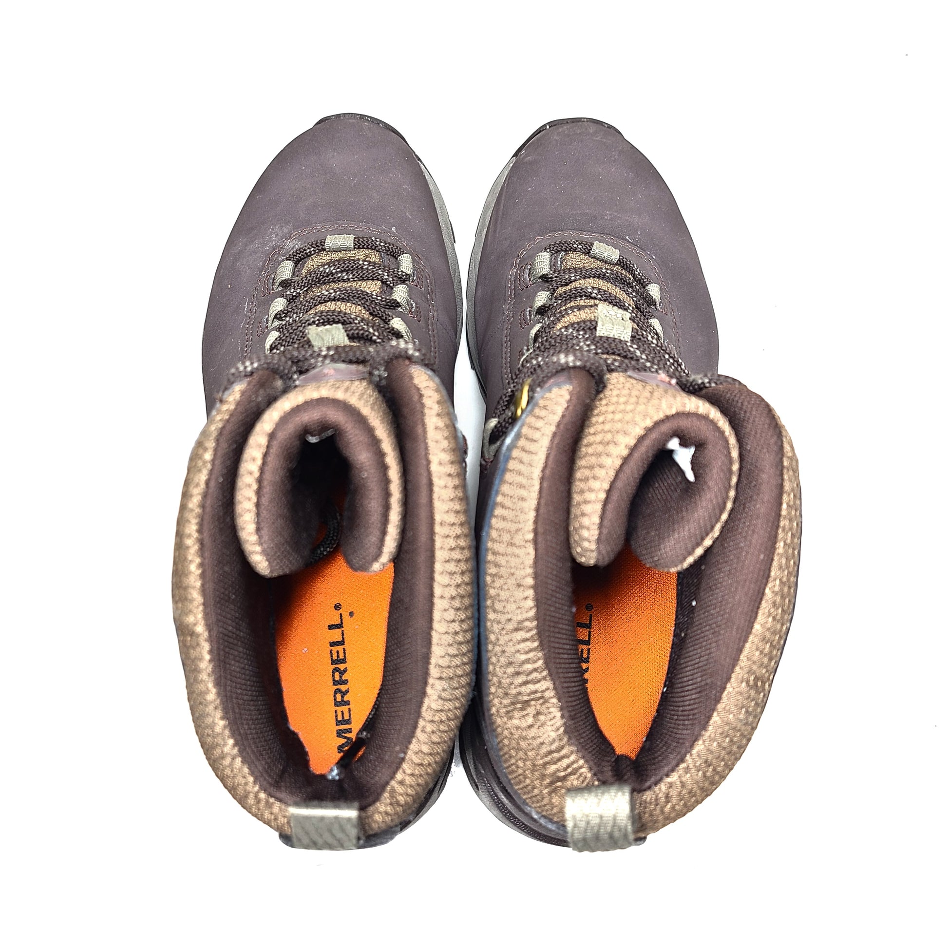 A pair of brown Merrell men's waterproof hiking boots on a rugged trail.