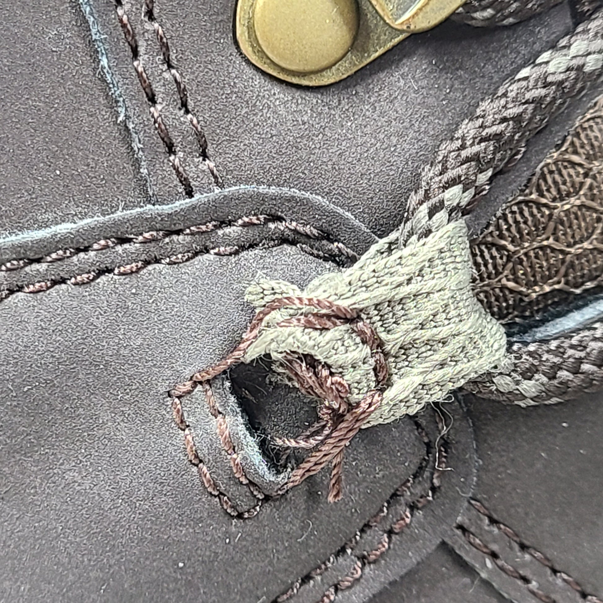 A pair of brown Merrell men's waterproof hiking boots on a rugged trail.