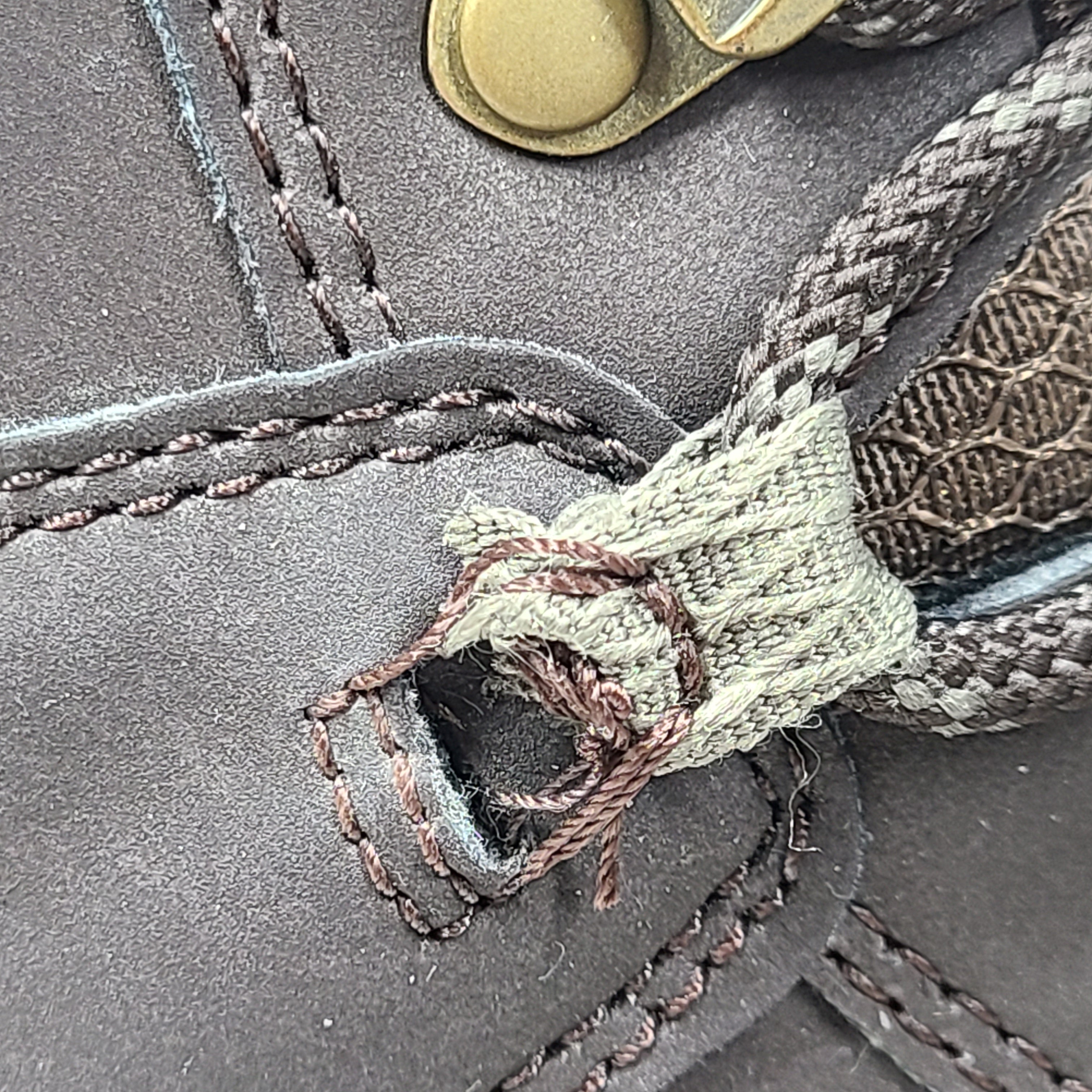 A pair of brown Merrell men's waterproof hiking boots on a rugged trail.