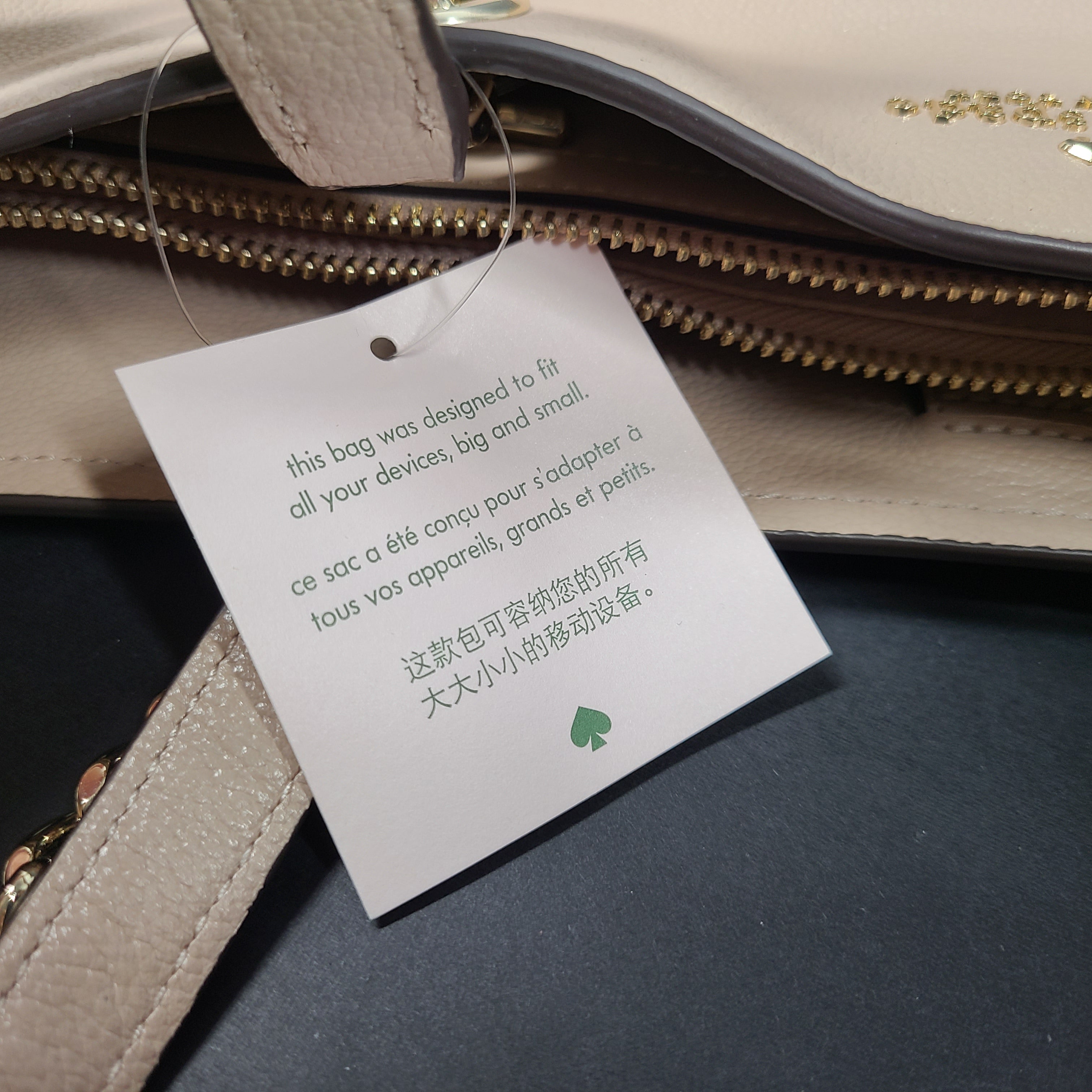 Beige Kate Spade leather tote with chain handles and gold hardware