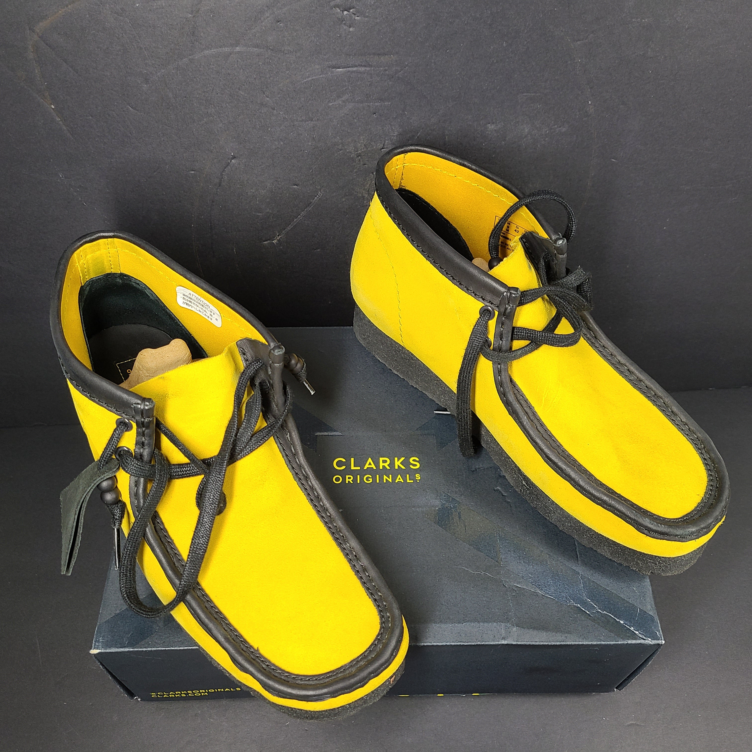 A pair of vibrant yellow Clarks Originals Jamaica Bee shoes.