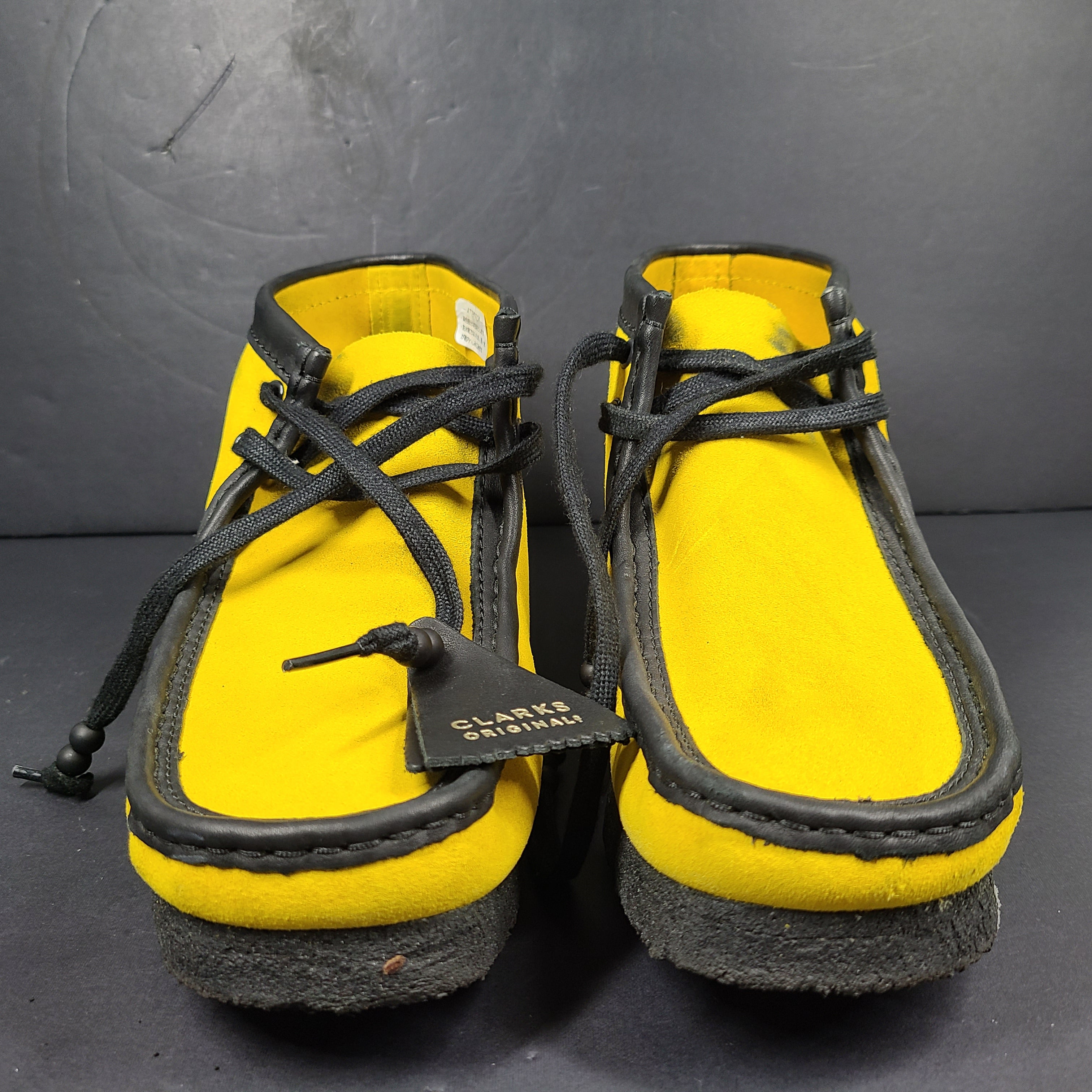 A pair of vibrant yellow Clarks Originals Jamaica Bee shoes.